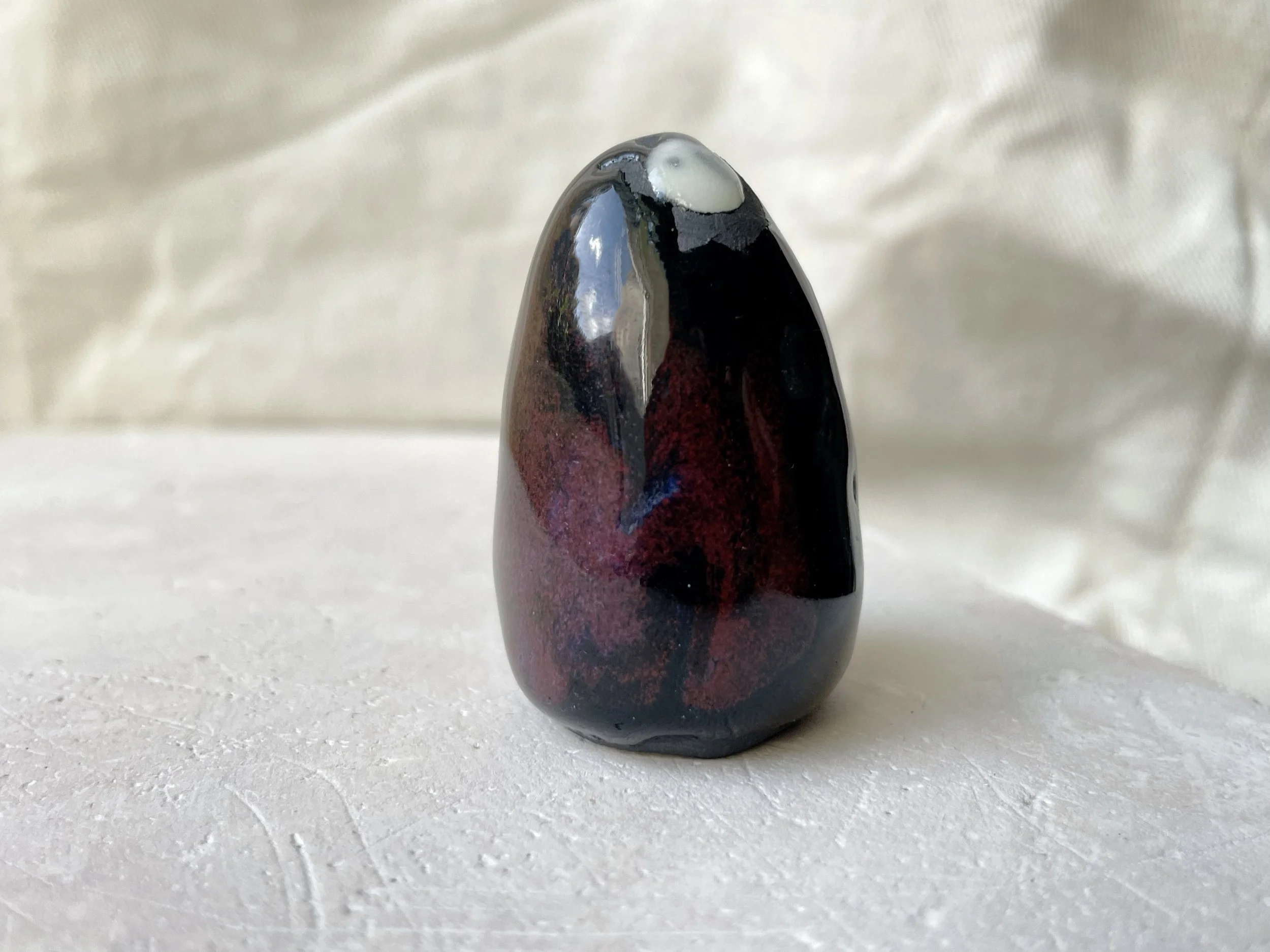 black and red handmade figurative ceramic sculpture with runny glaze