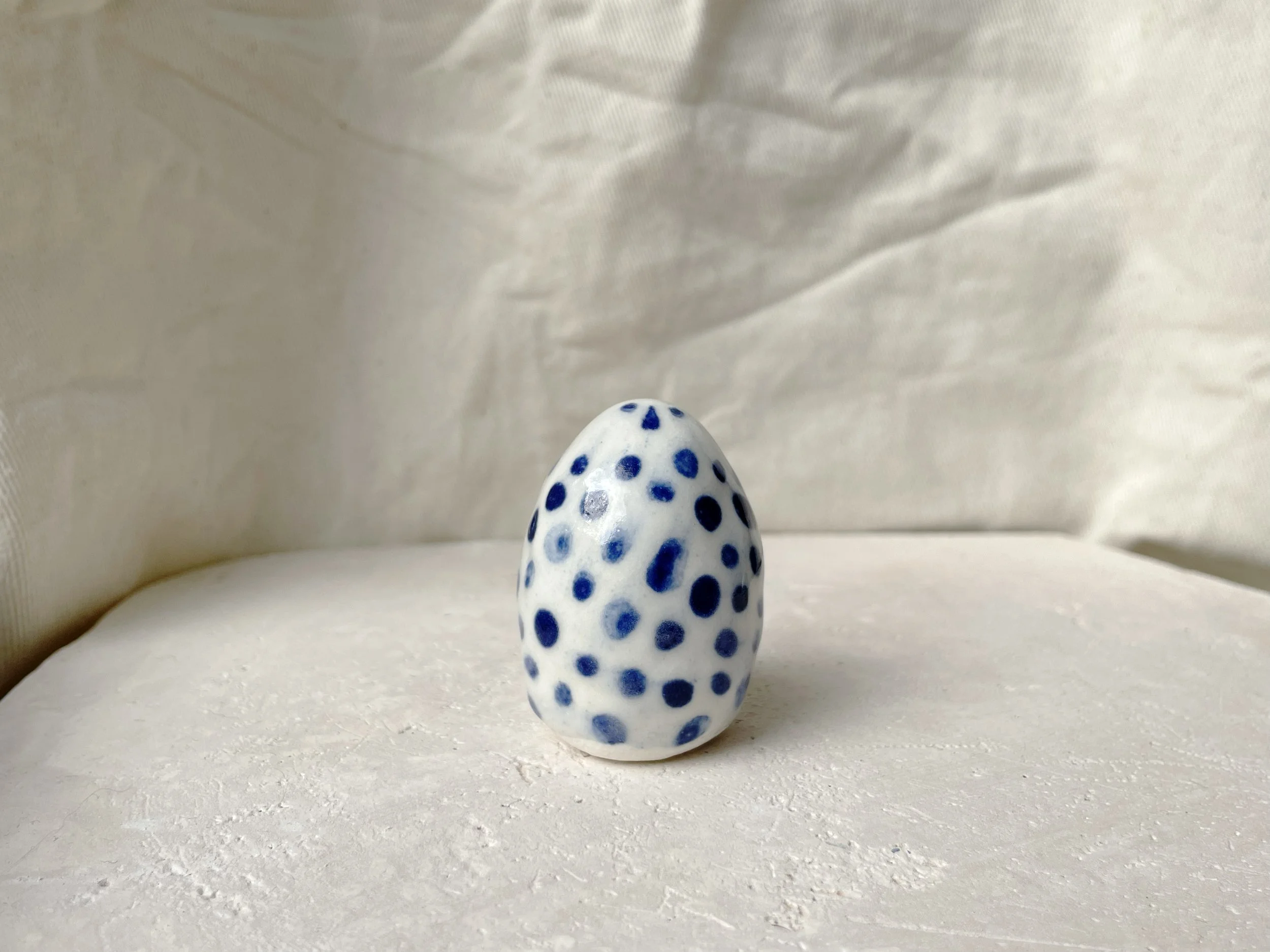blue and white handmade figurative ceramic sculpture with cobalt oxide and glaze