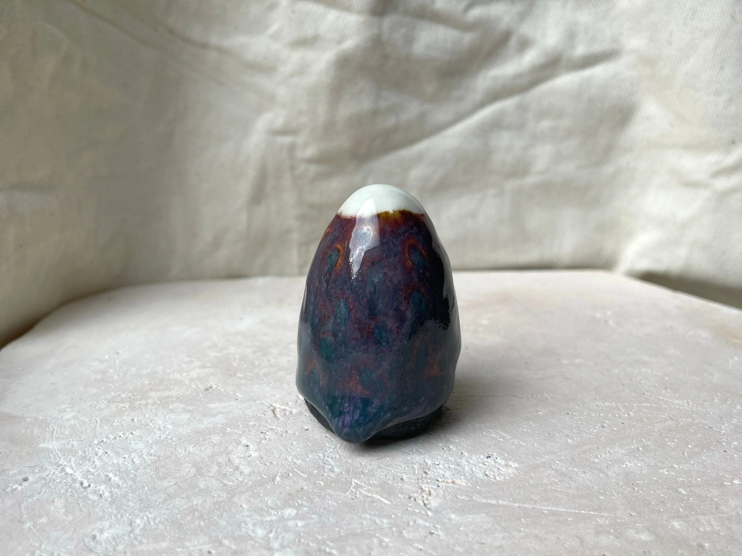 Purple, black and red handmade figurative ceramic sculpture with underglaze and floating glaze