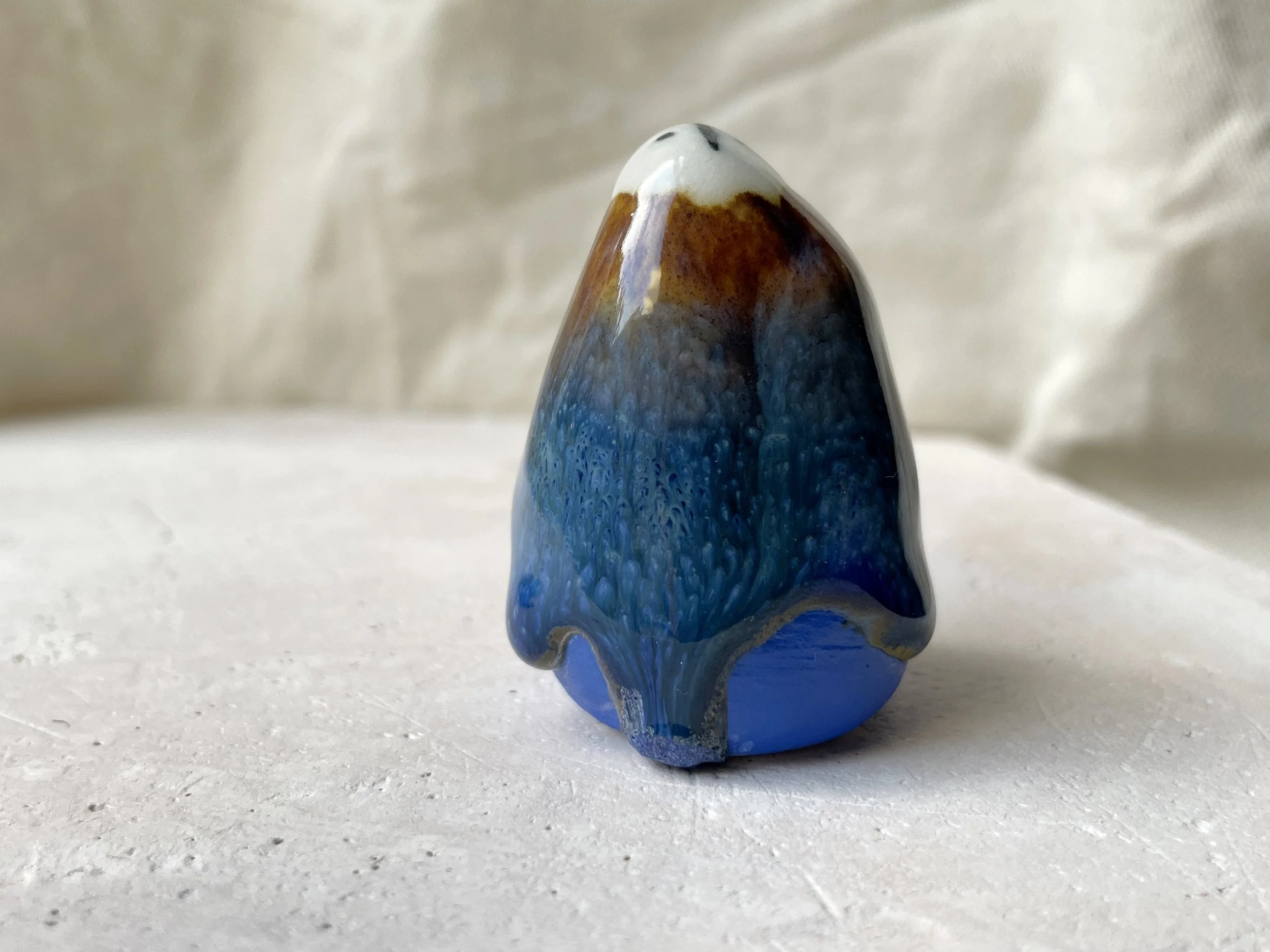 Blue and brown handmade figurative ceramic sculpture with underglaze and drippy float glaze