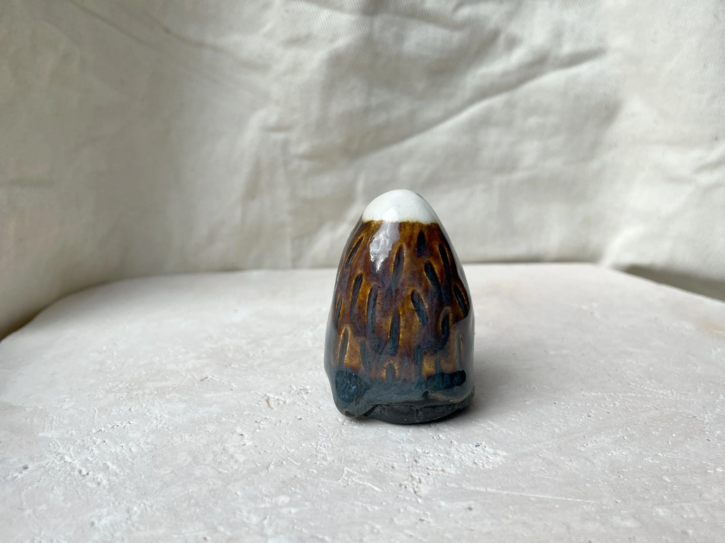 Brown. blue and black handmade figurative ceramic sculpture with underglaze and floating glaze