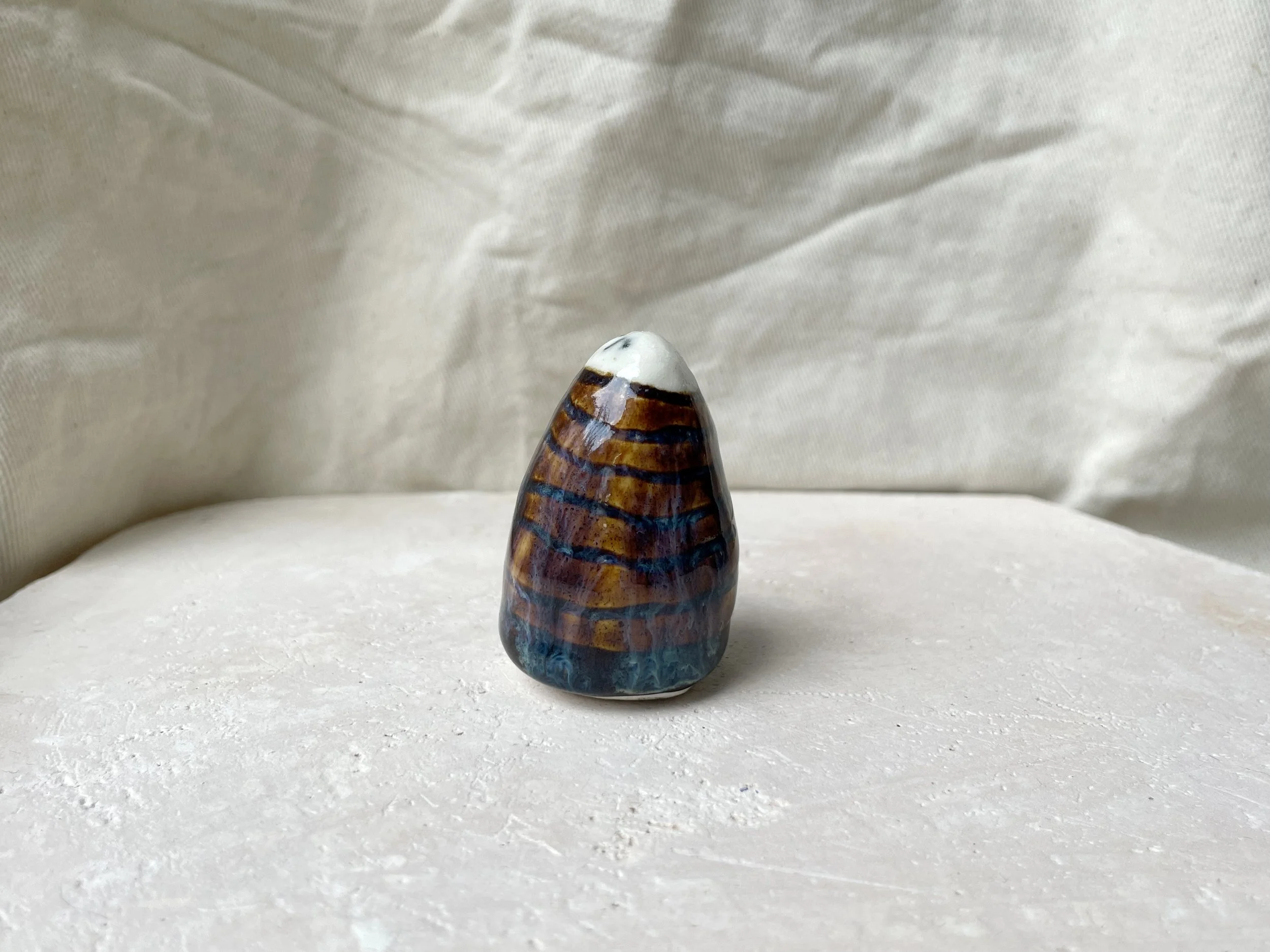 brown, purple and blue handmade figurative ceramic sculpture with underglaze and drippy float glaze