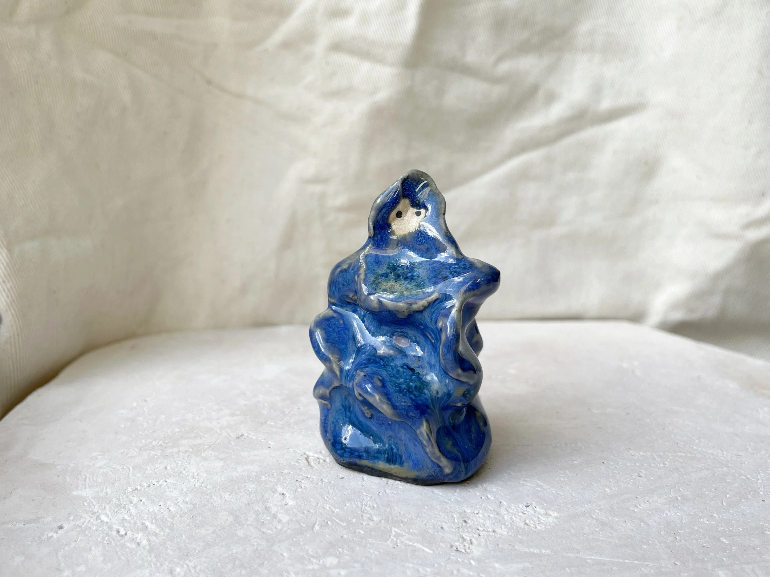 blue wavey handmade figurative ceramic sculpture with runny glaze