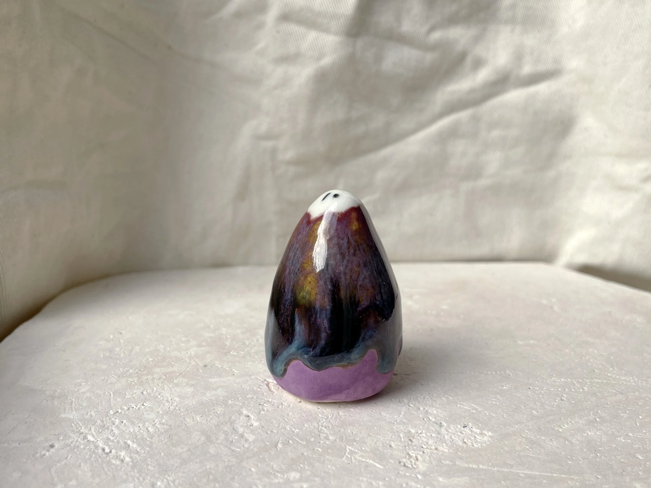 blue, orange, purple and red handmade figurative ceramic sculpture with glossy drippy floating glaze