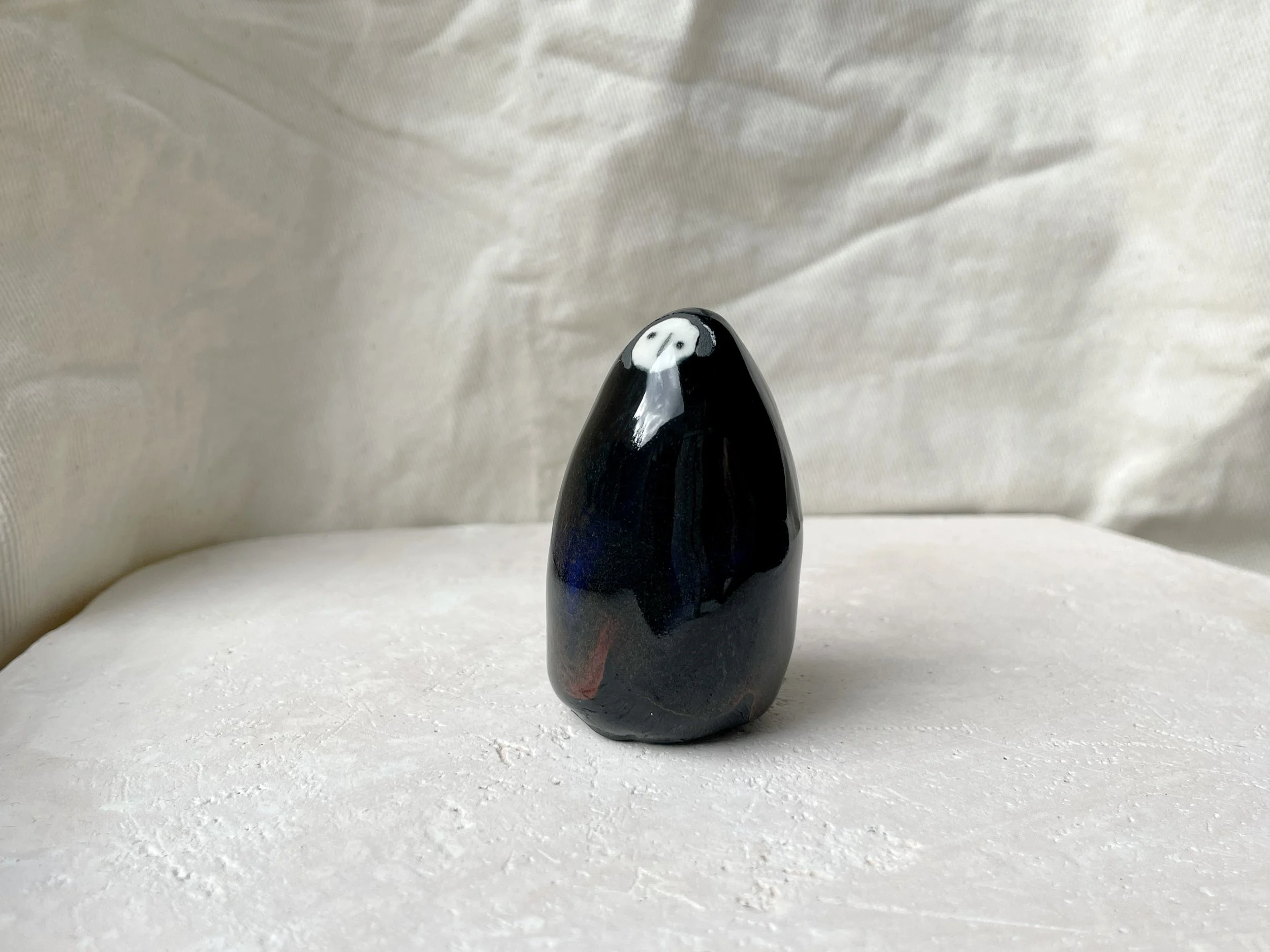 black blue and red handmade figurative ceramic sculpture with glossy floating glaze