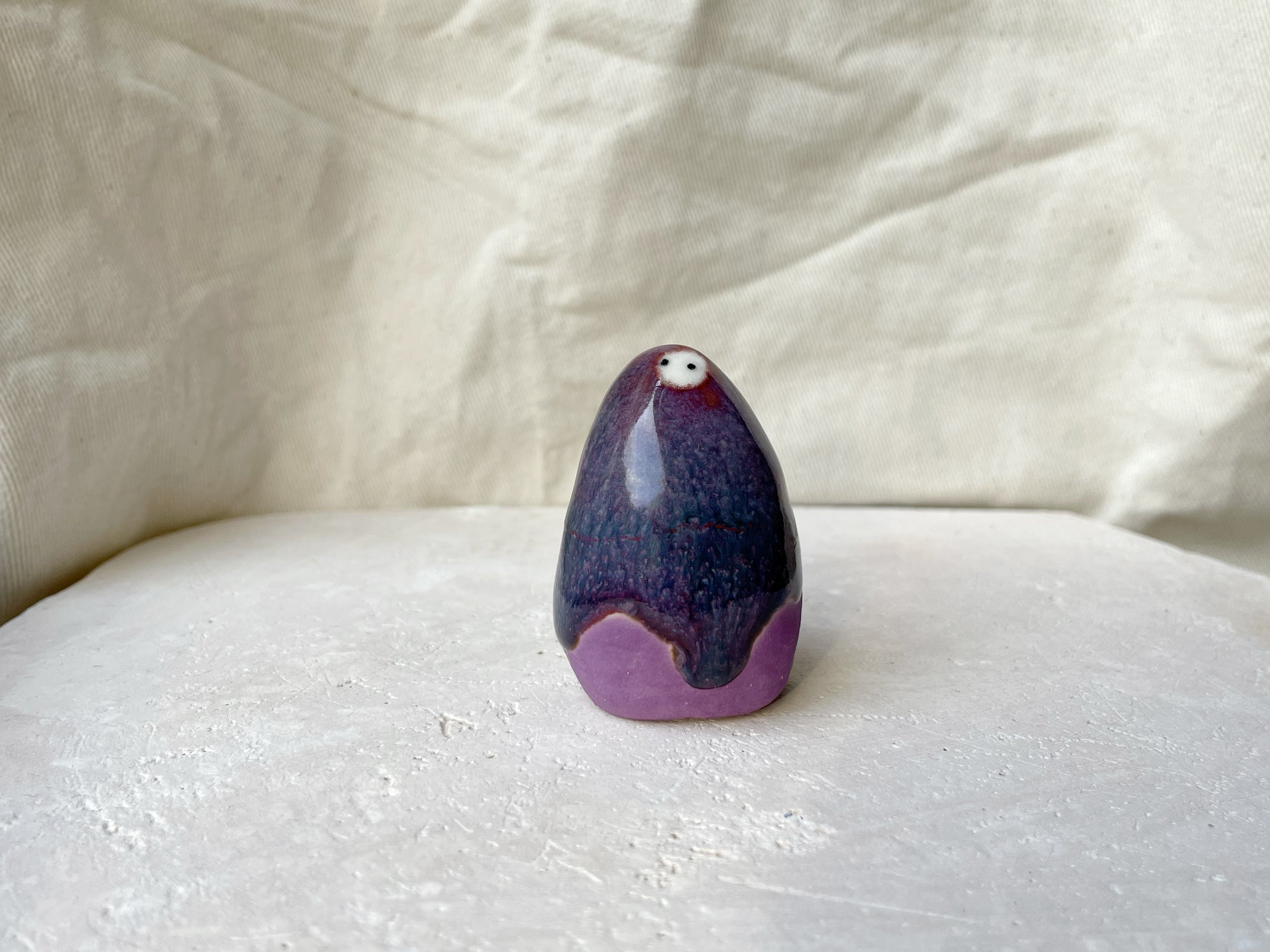 Purple, lilac and red handmade figurative ceramic sculpture with glossy drippy glaze