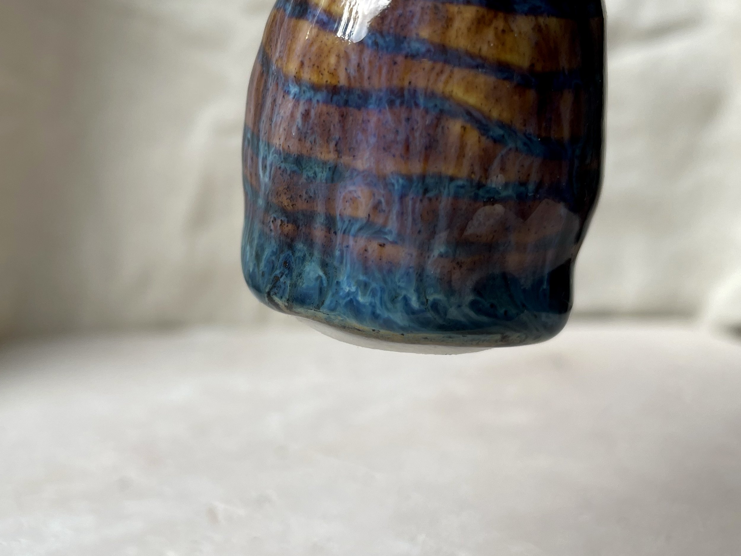 Brown and blue handmade figurative ceramic sculpture with underglaze and runny glaze