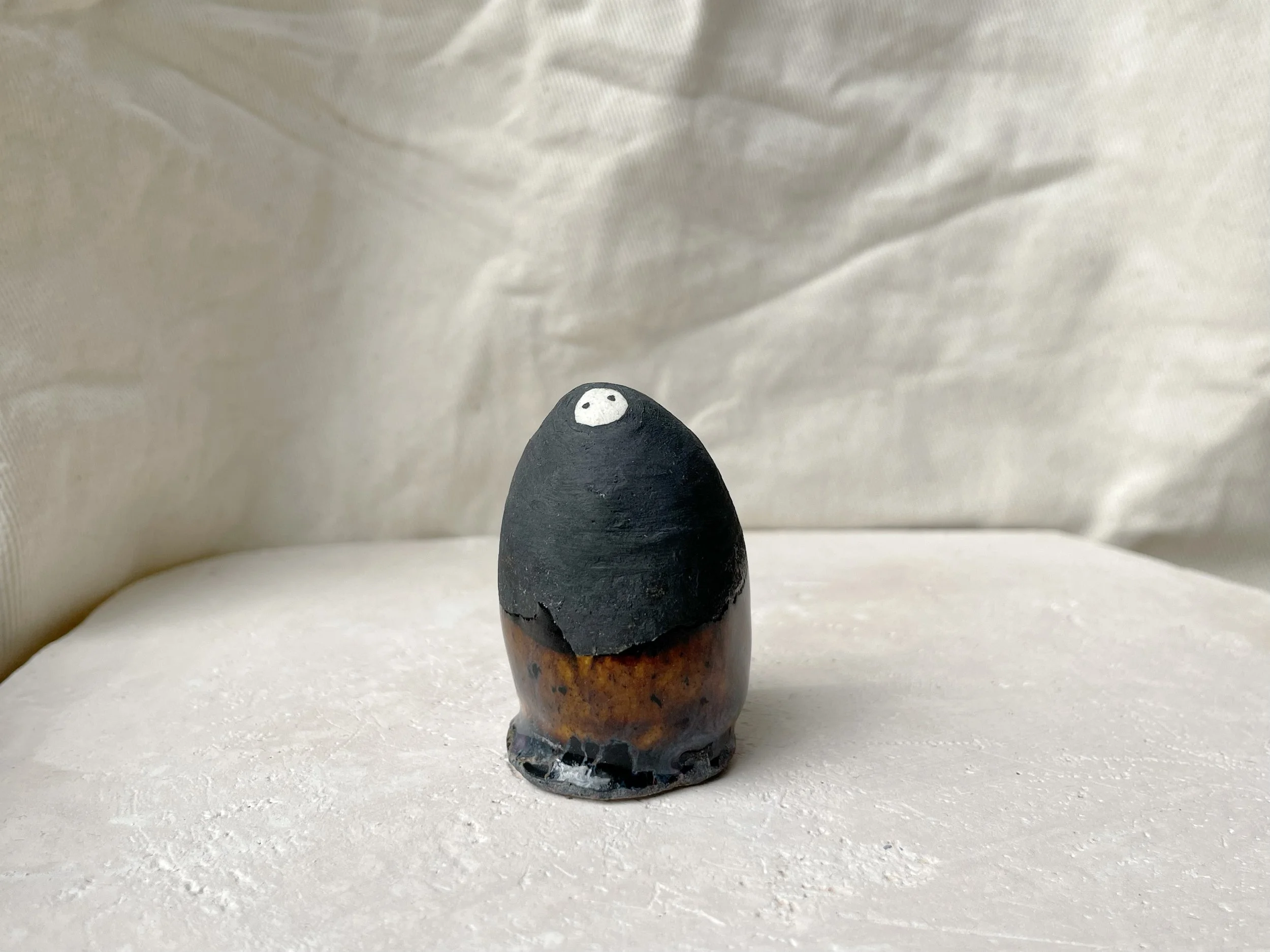 black and brown handmade figurative ceramic sculpture with matt and runny glaze