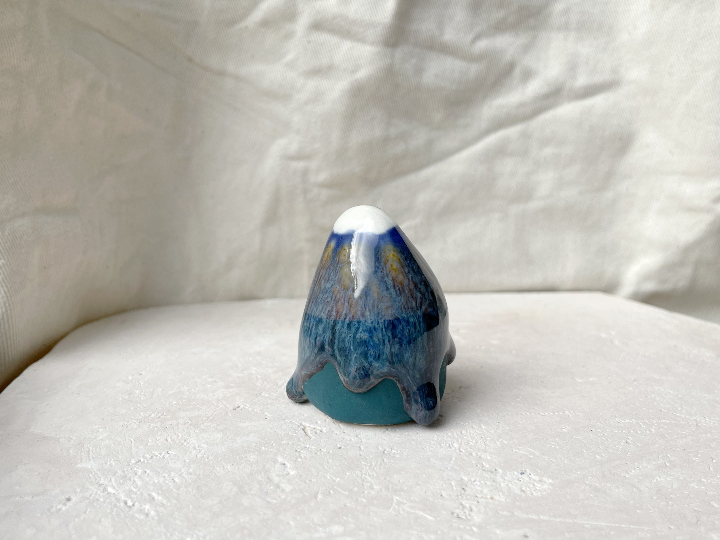Blue and green handmade figurative ceramic sculpture with underglaze and runny glaze