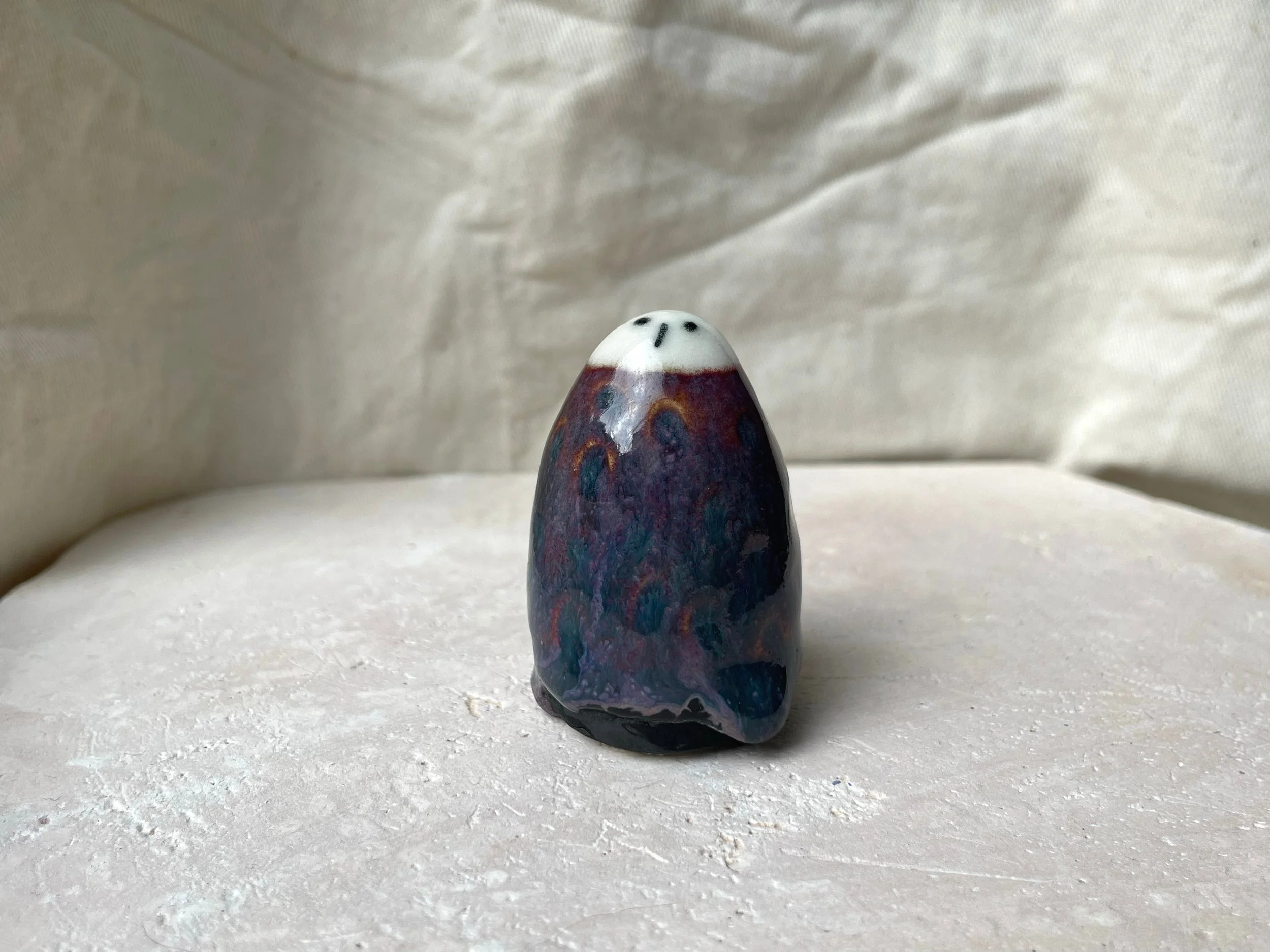 Purple, black and red handmade figurative ceramic sculpture with underglaze and floating glaze