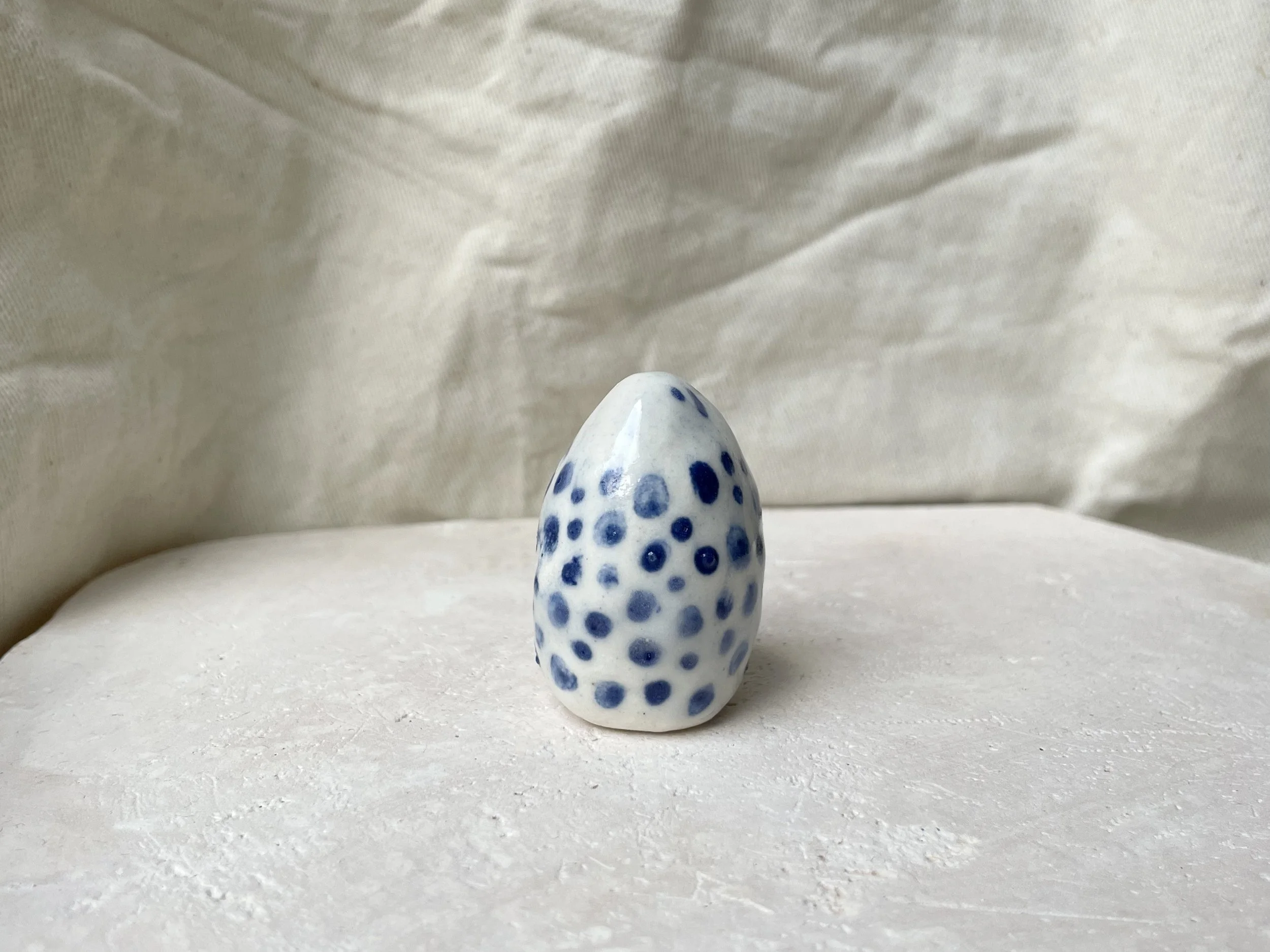 White and blue glossy dotty handmade figurative ceramic sculpture