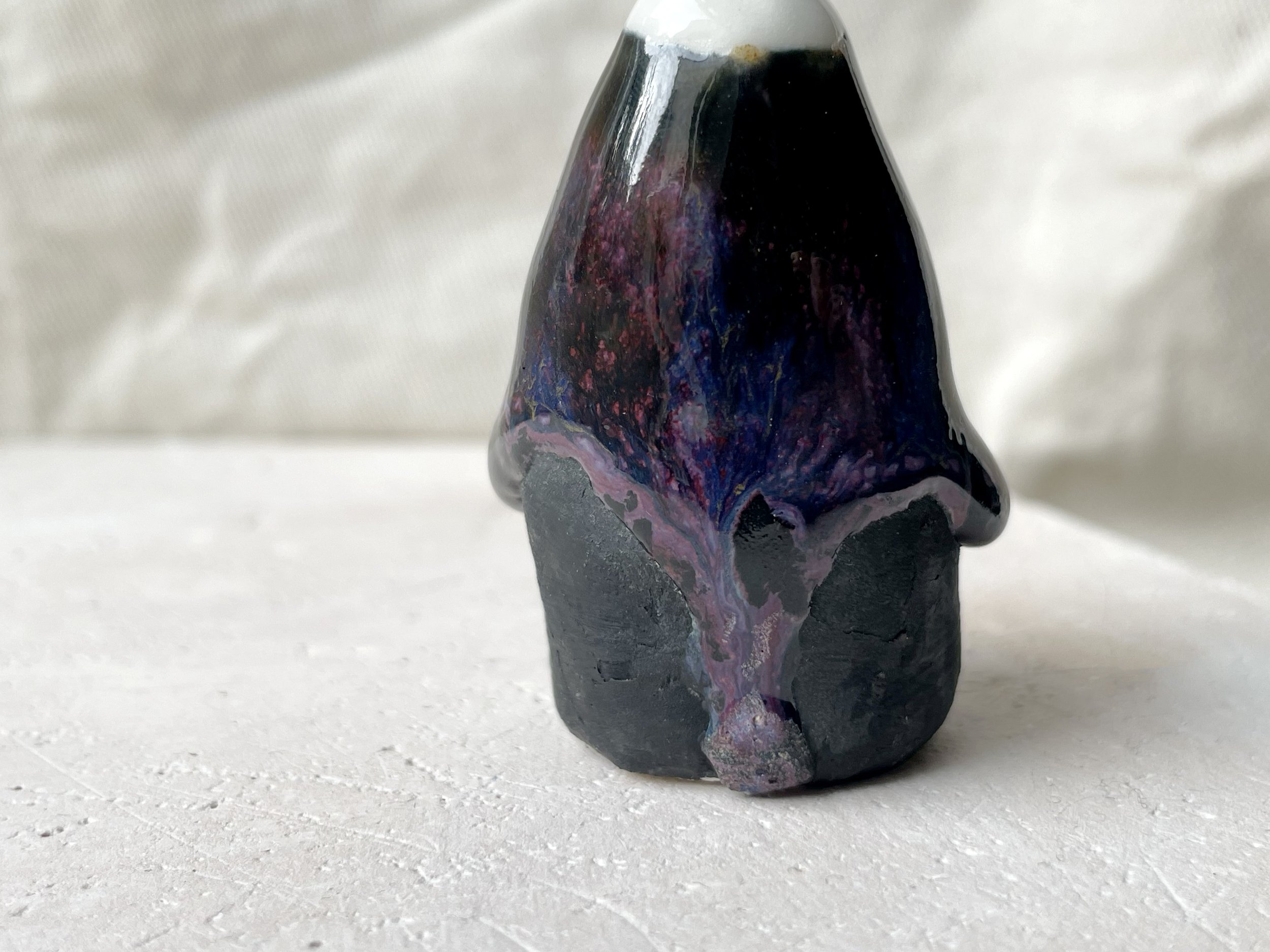 black, lilac and purple drippy handmade figurative ceramic sculpture with glossy floating glaze