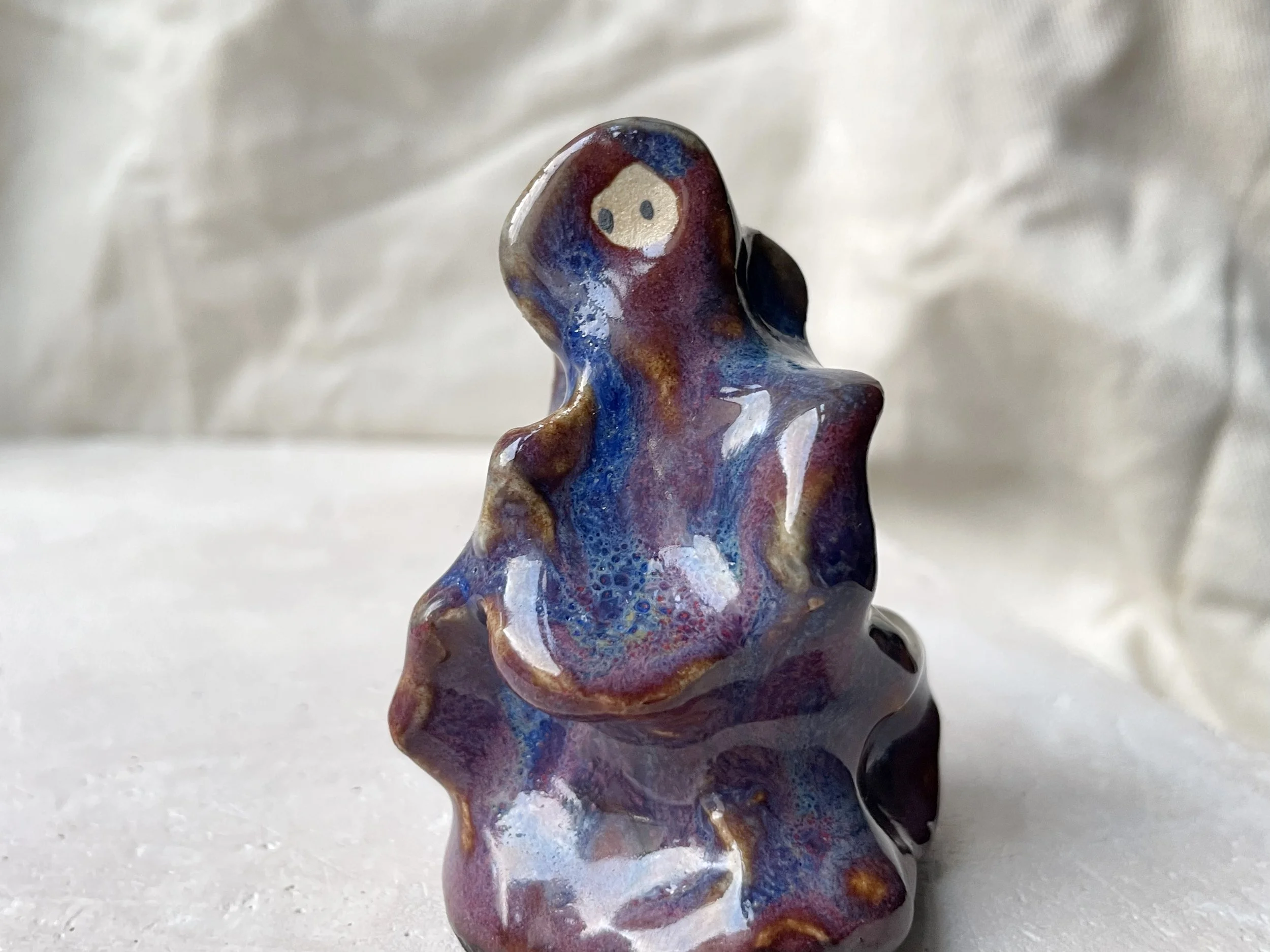 Wavy purple, red and blue handmade figurative ceramic sculpture with glossy floating glaze and underglaze