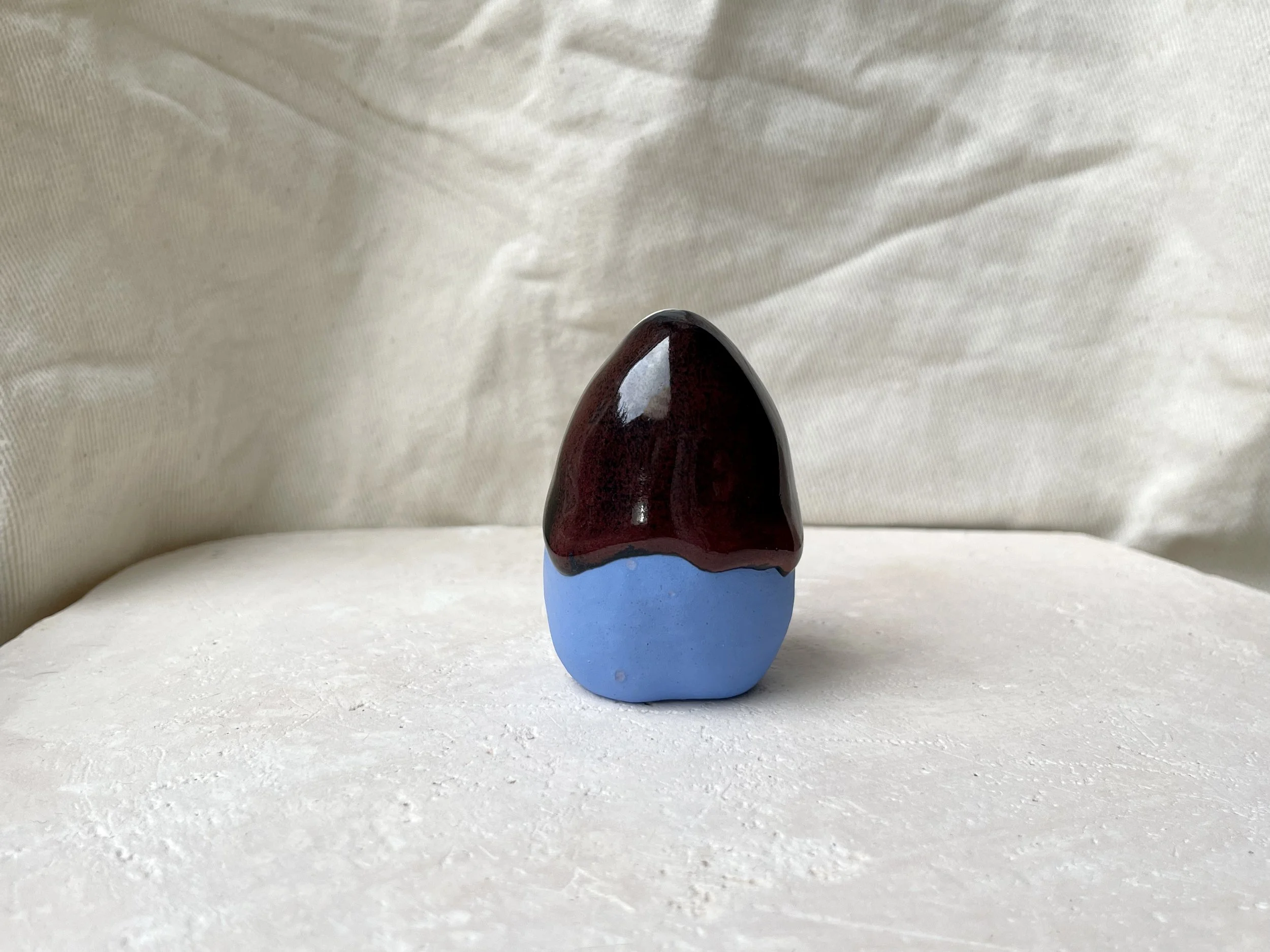 Blue, red and black handmade figurative ceramic sculpture with underglaze and drippy float glaze