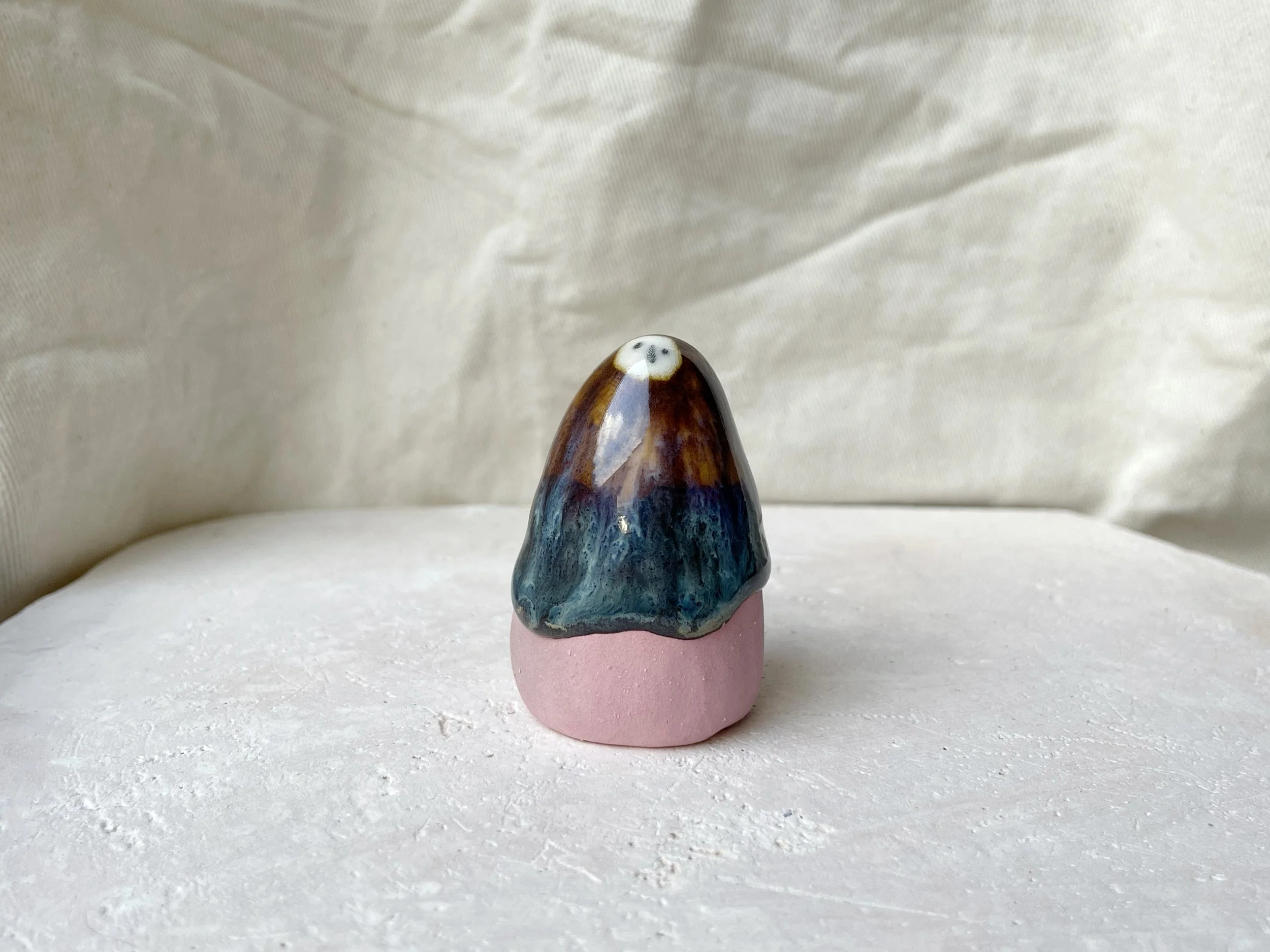 Pink, brown and green and cream handmade figurative ceramic sculpture with glossy drippy glaze