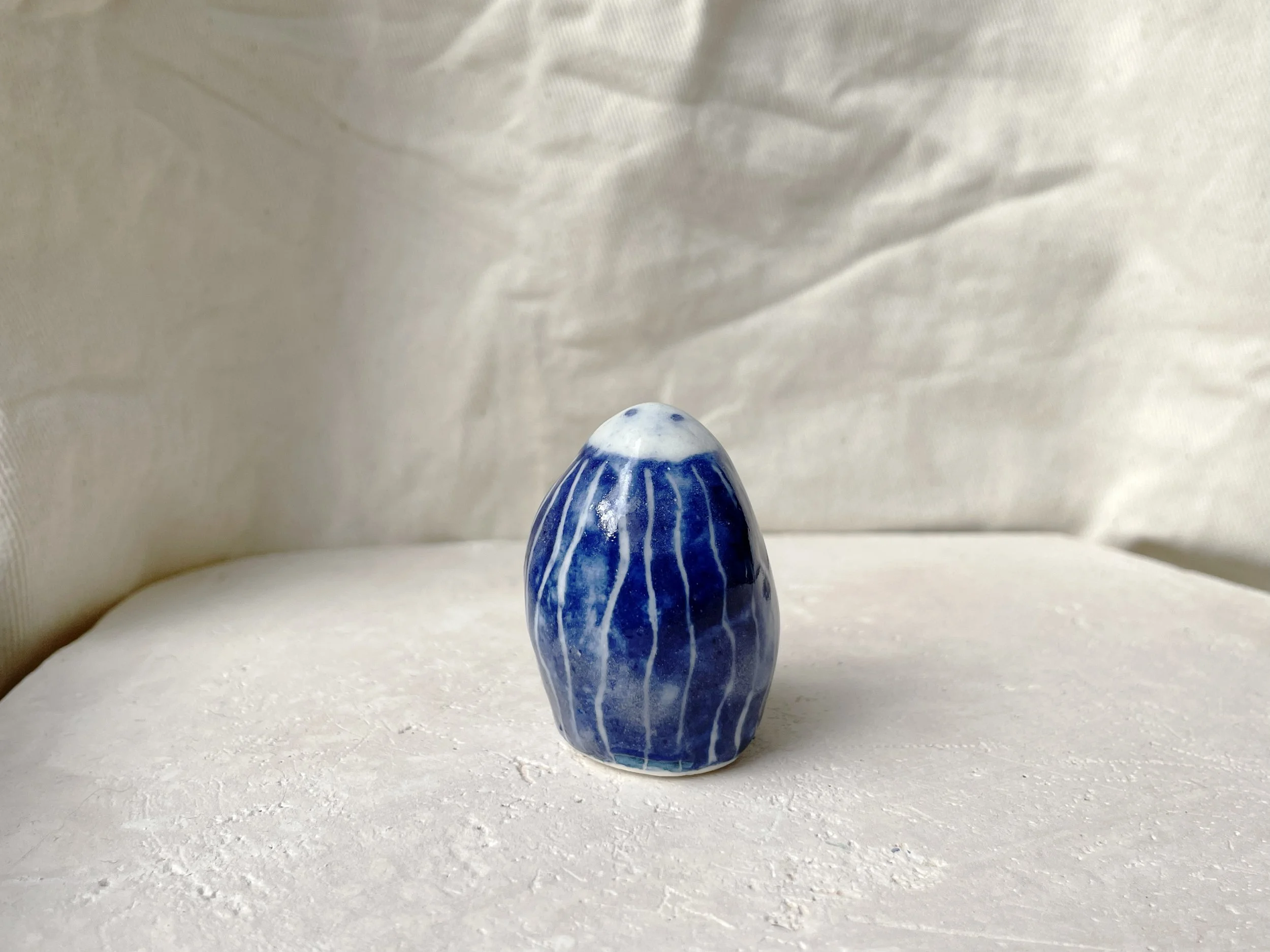 blue and white handmade figurative ceramic sculpture with cobalt oxide and glaze