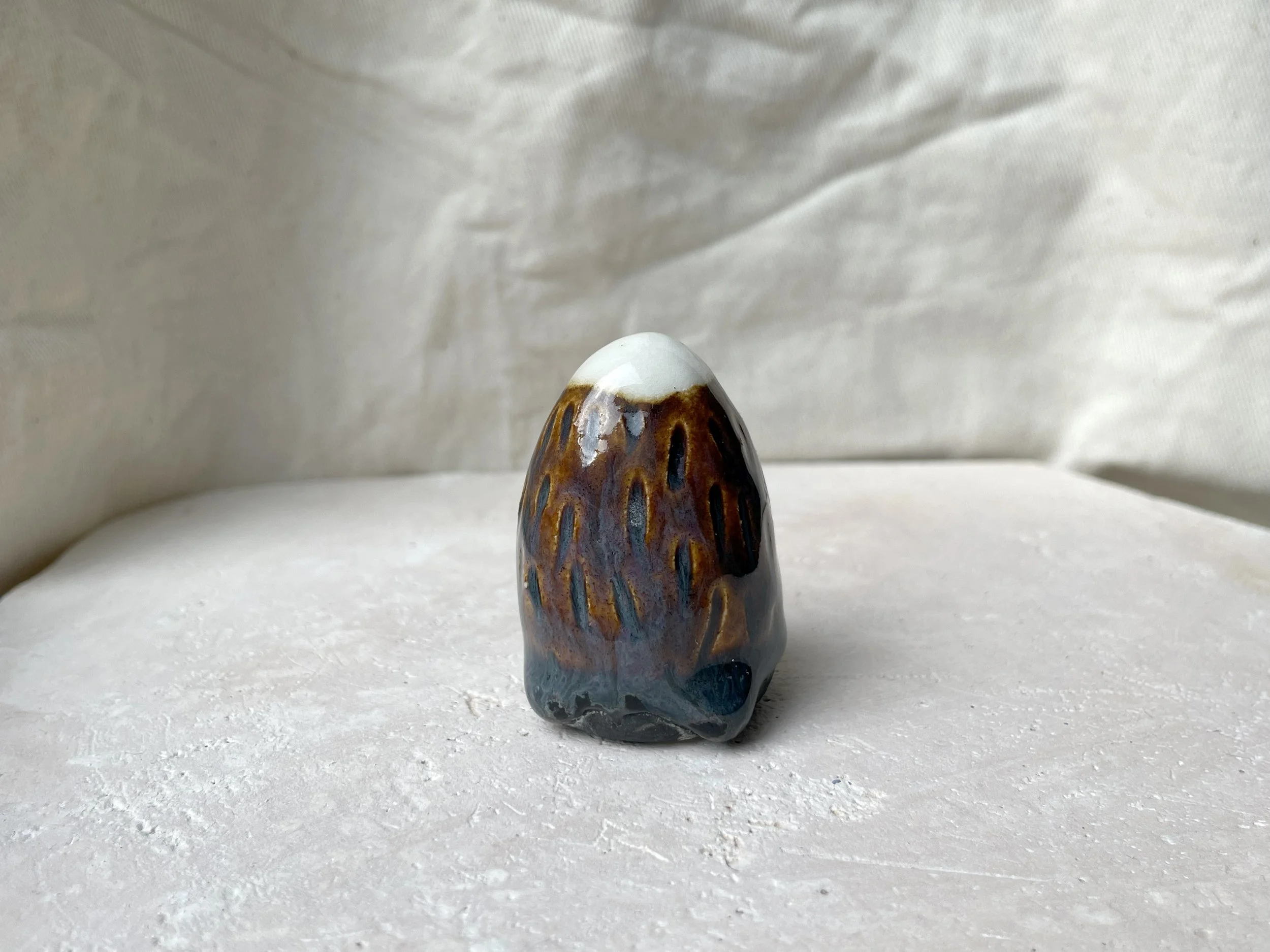 Brown. blue and black handmade figurative ceramic sculpture with underglaze and floating glaze