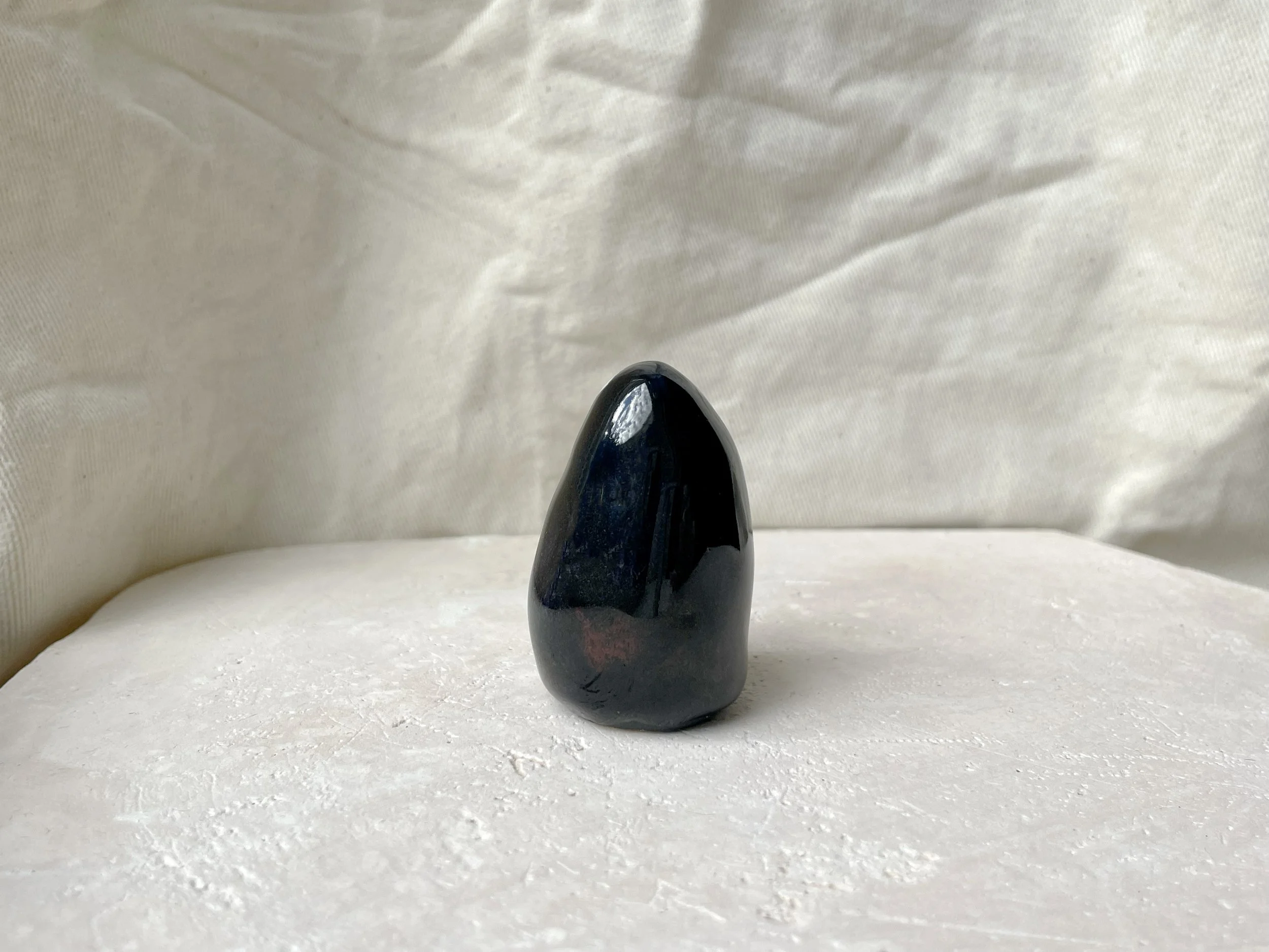 black and red handmade figurative ceramic sculpture with runny floating glaze