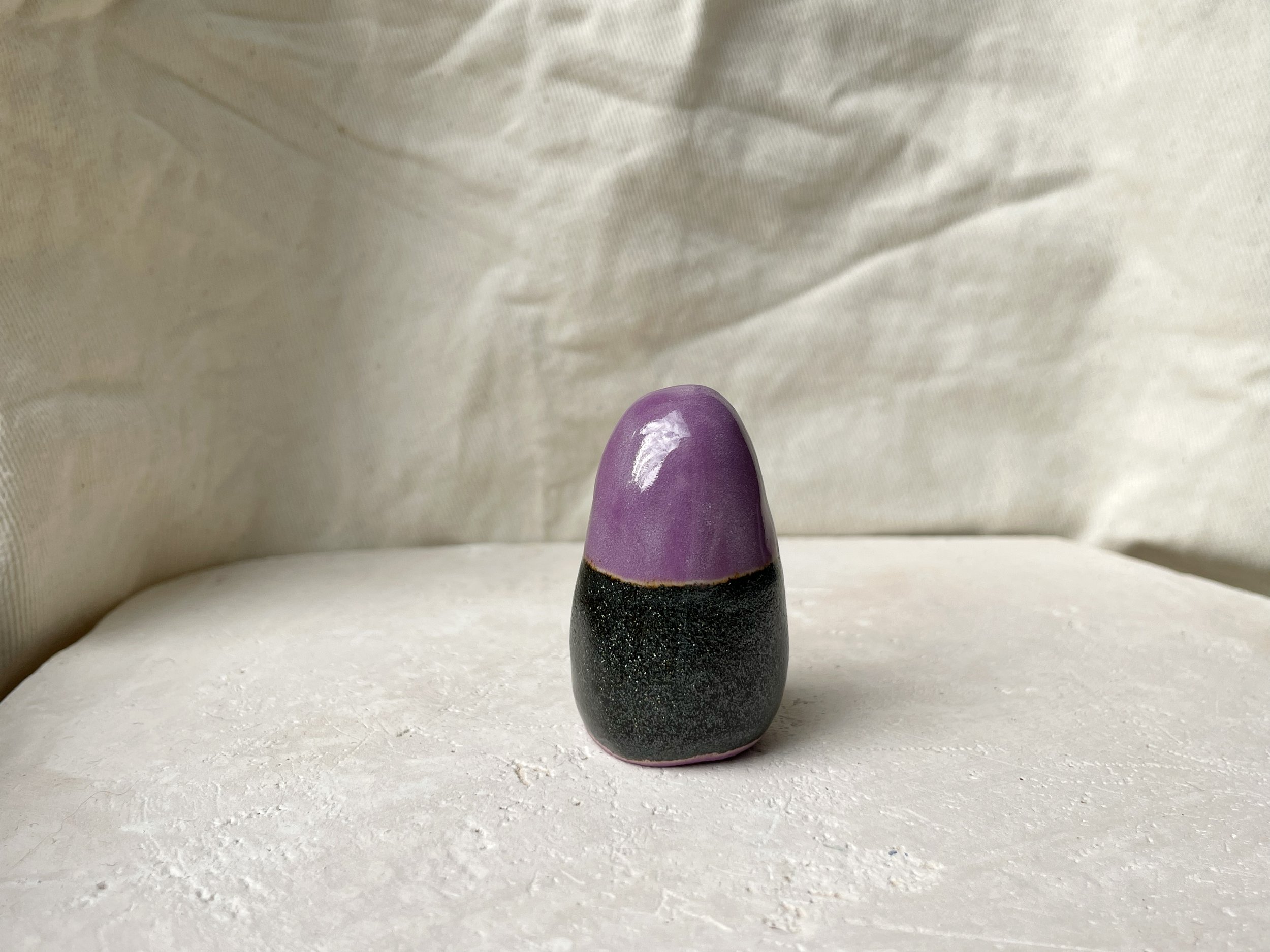 Purple and sparkly black handmade figurative ceramic sculpture with underglaze and glaze