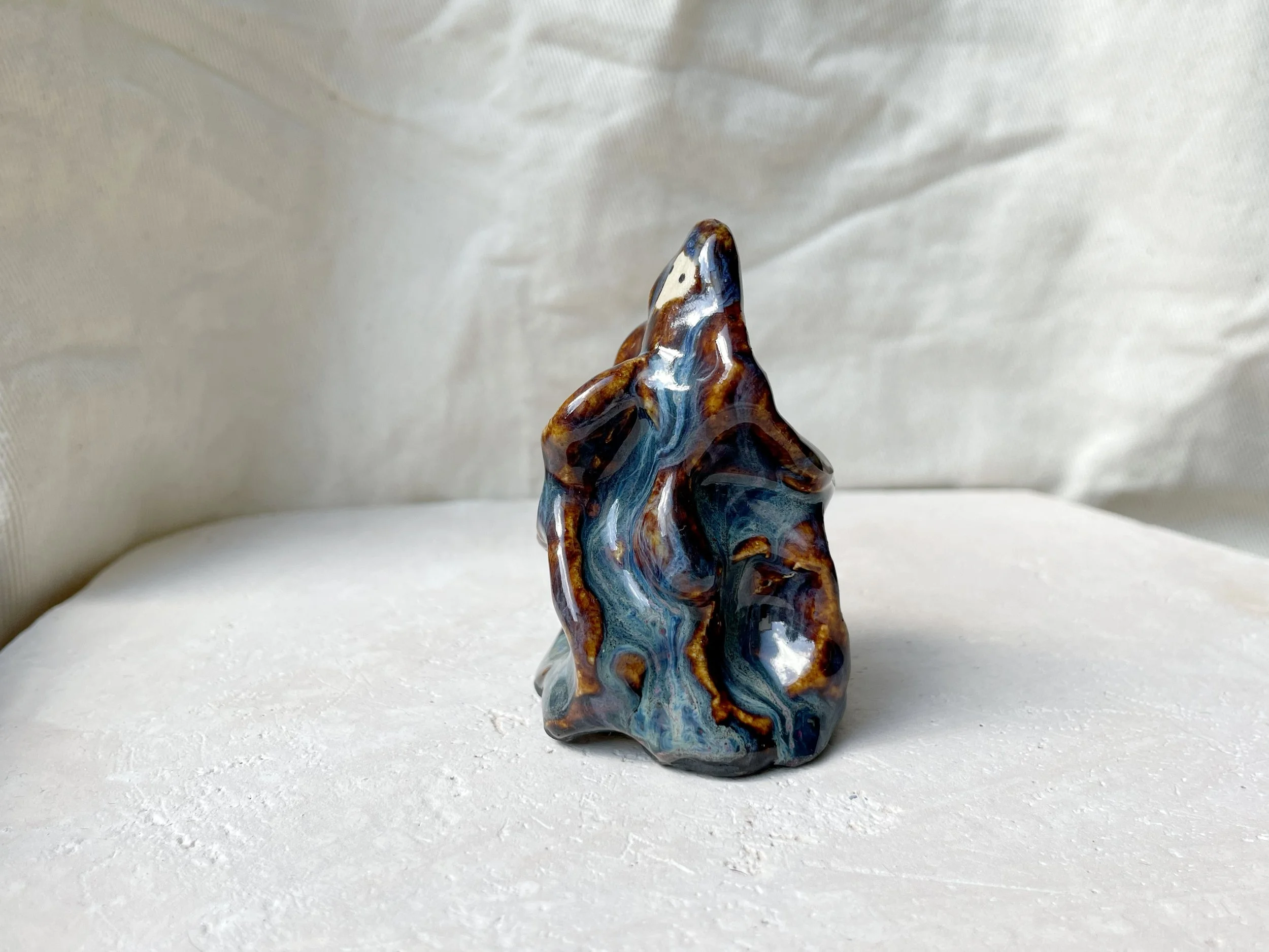 blue and brown wavey handmade figurative ceramic sculpture with runny glaze