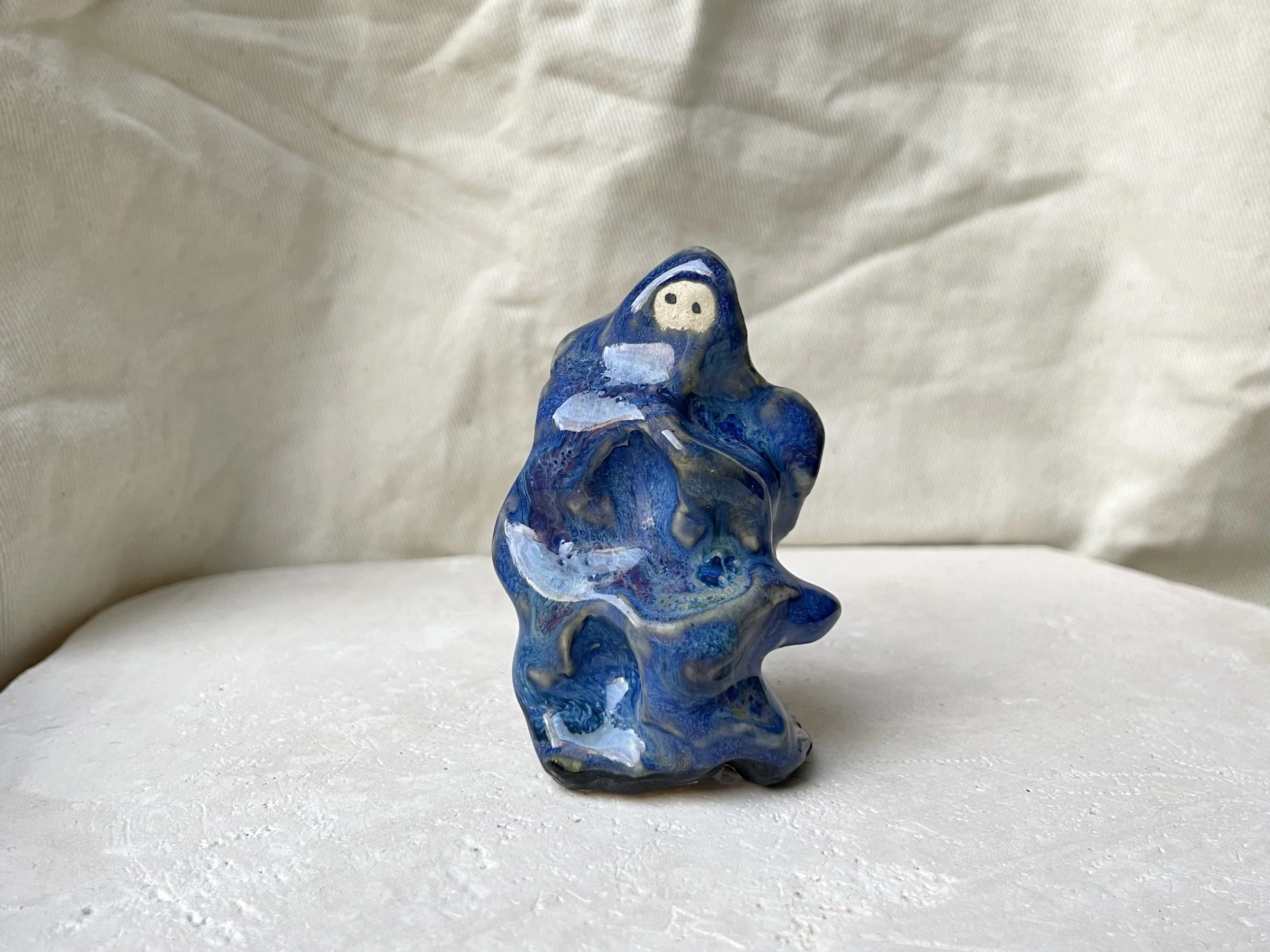 Wavy blue and red handmade figurative ceramic sculpture with glossy floating glaze and underglaze