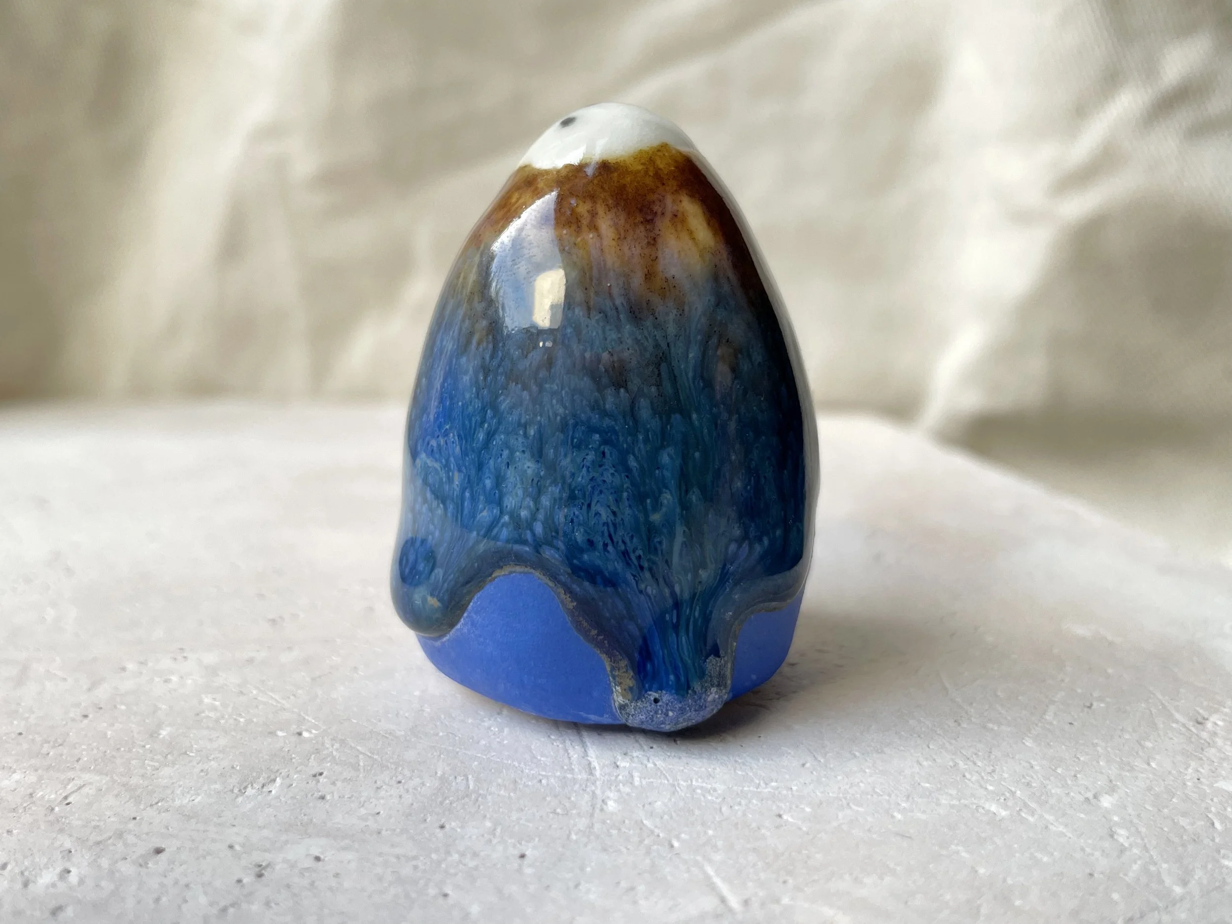 Blue and brown handmade figurative ceramic sculpture with underglaze and drippy float glaze