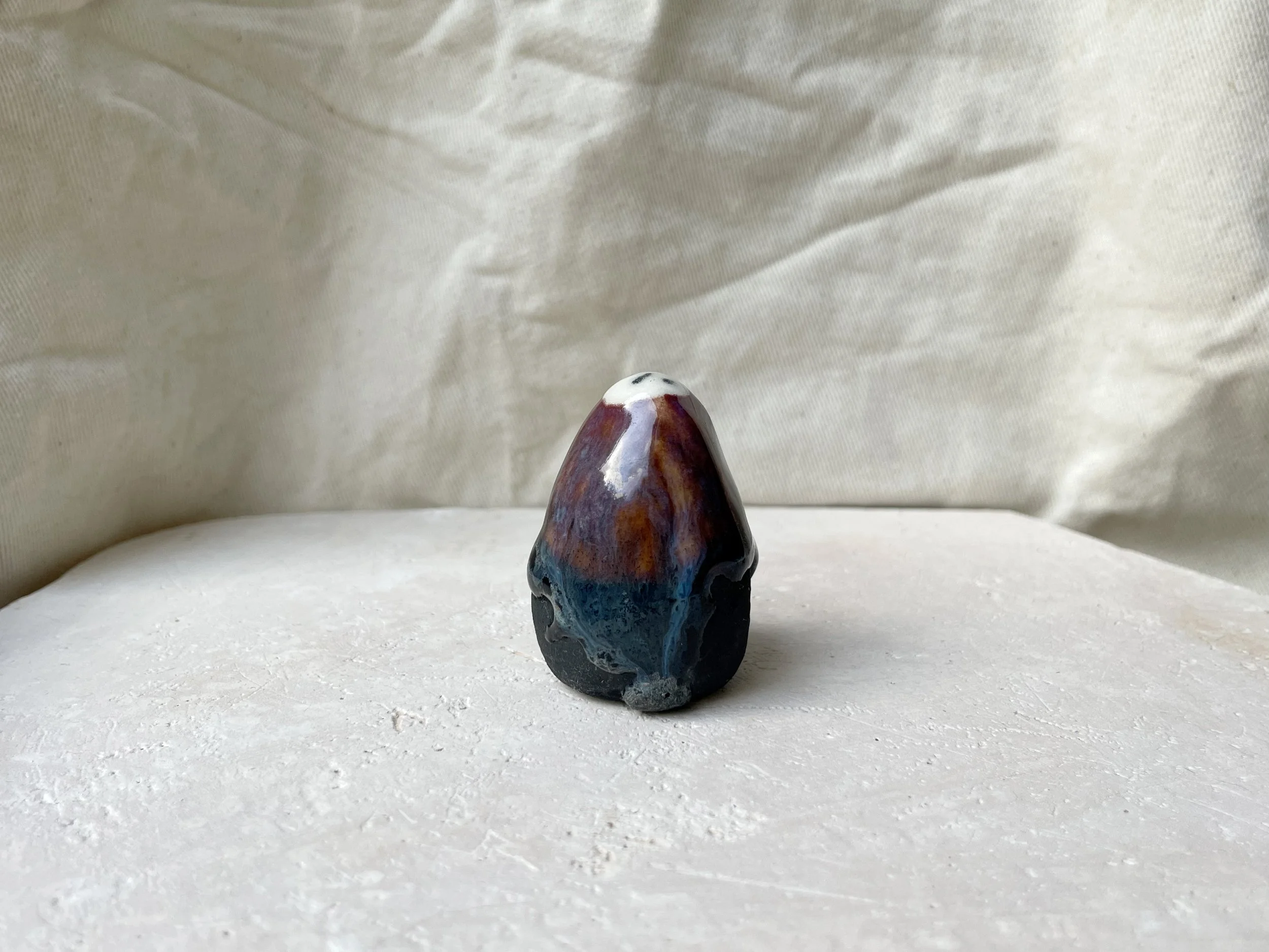 Blue, orange, purple and black handmade figurative ceramic sculpture with underglaze and drippy float glaze