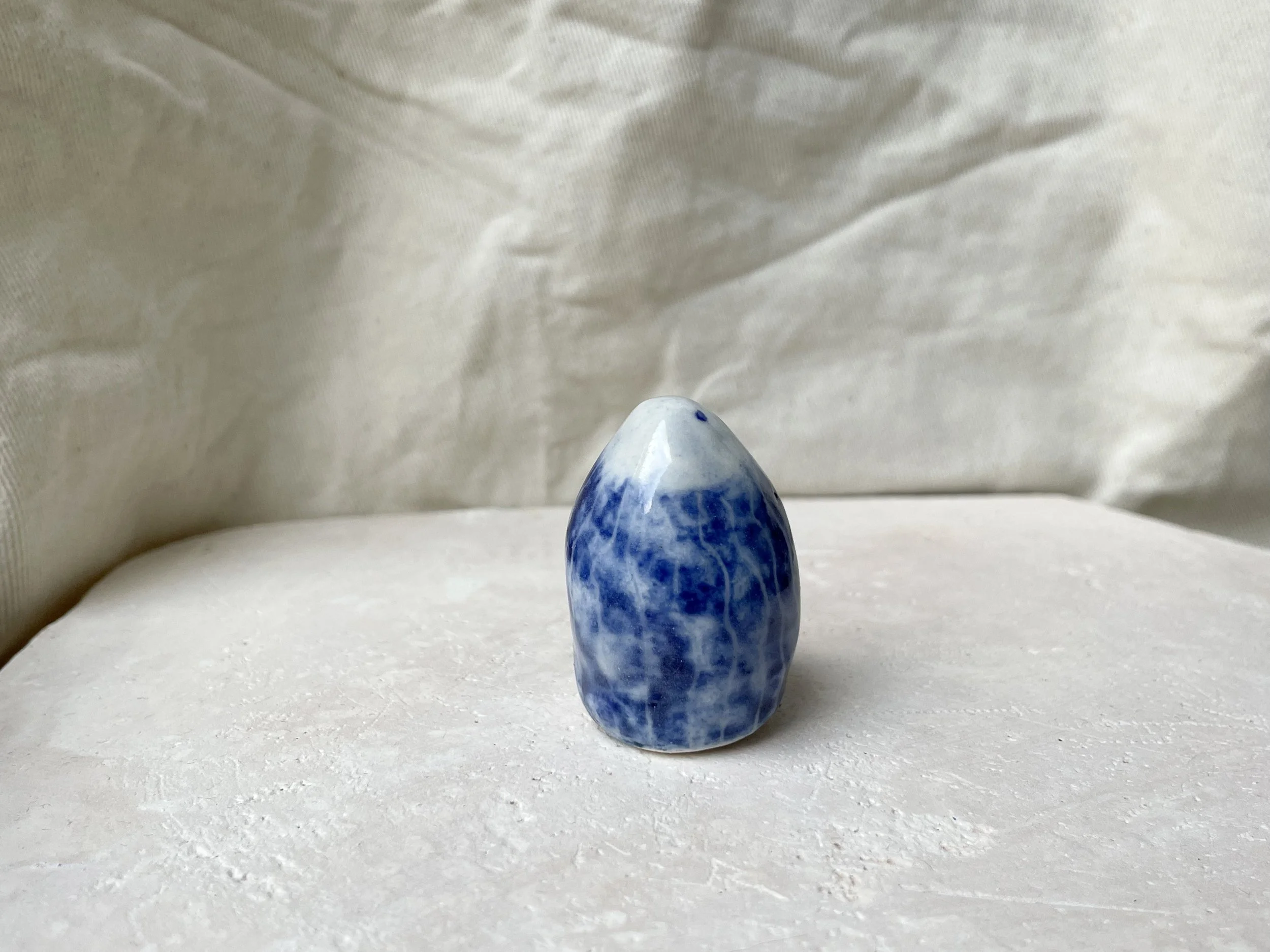 White and blue glossy dotty handmade figurative ceramic sculpture