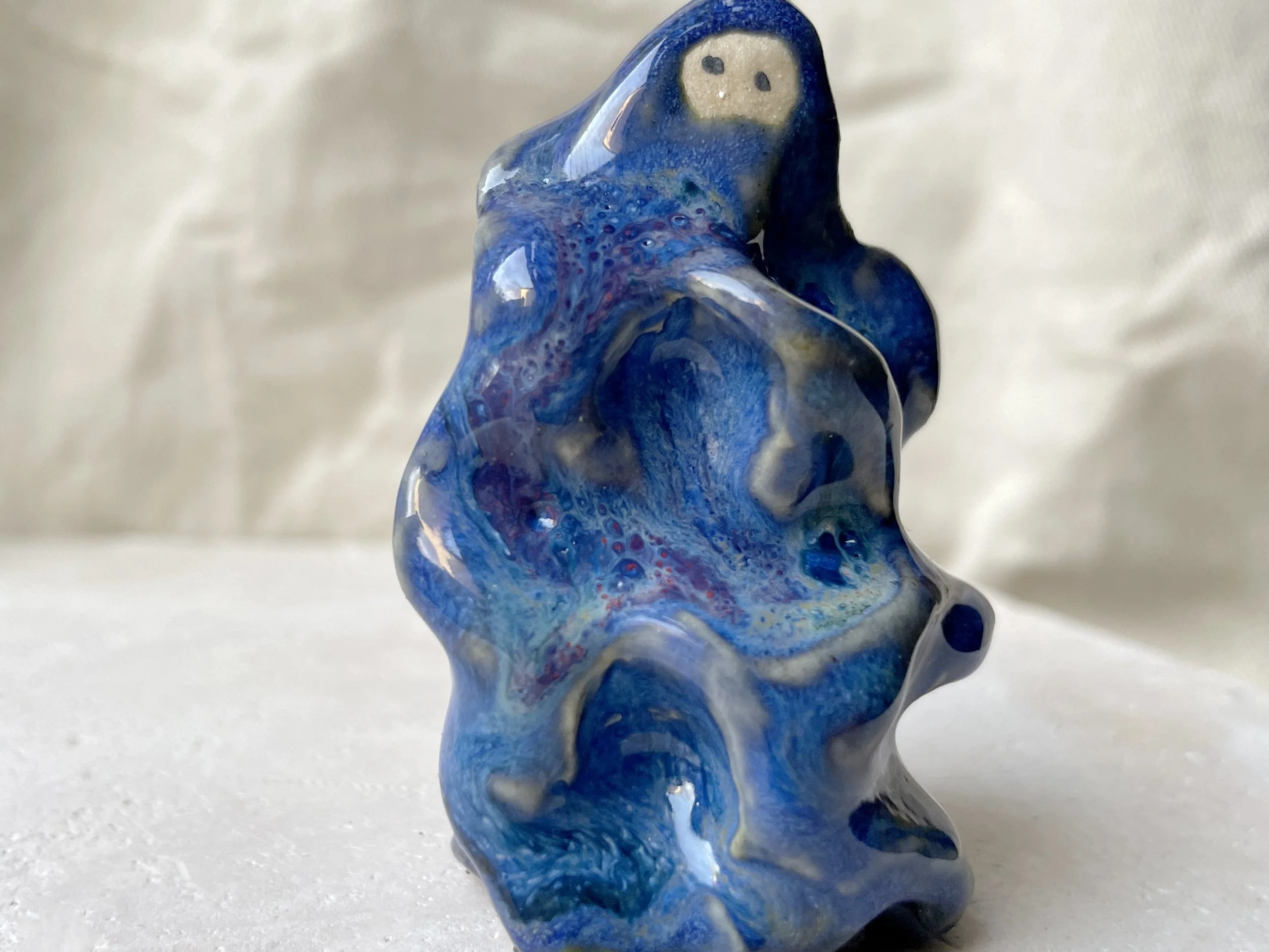 Wavy blue and red handmade figurative ceramic sculpture with glossy floating glaze and underglaze
