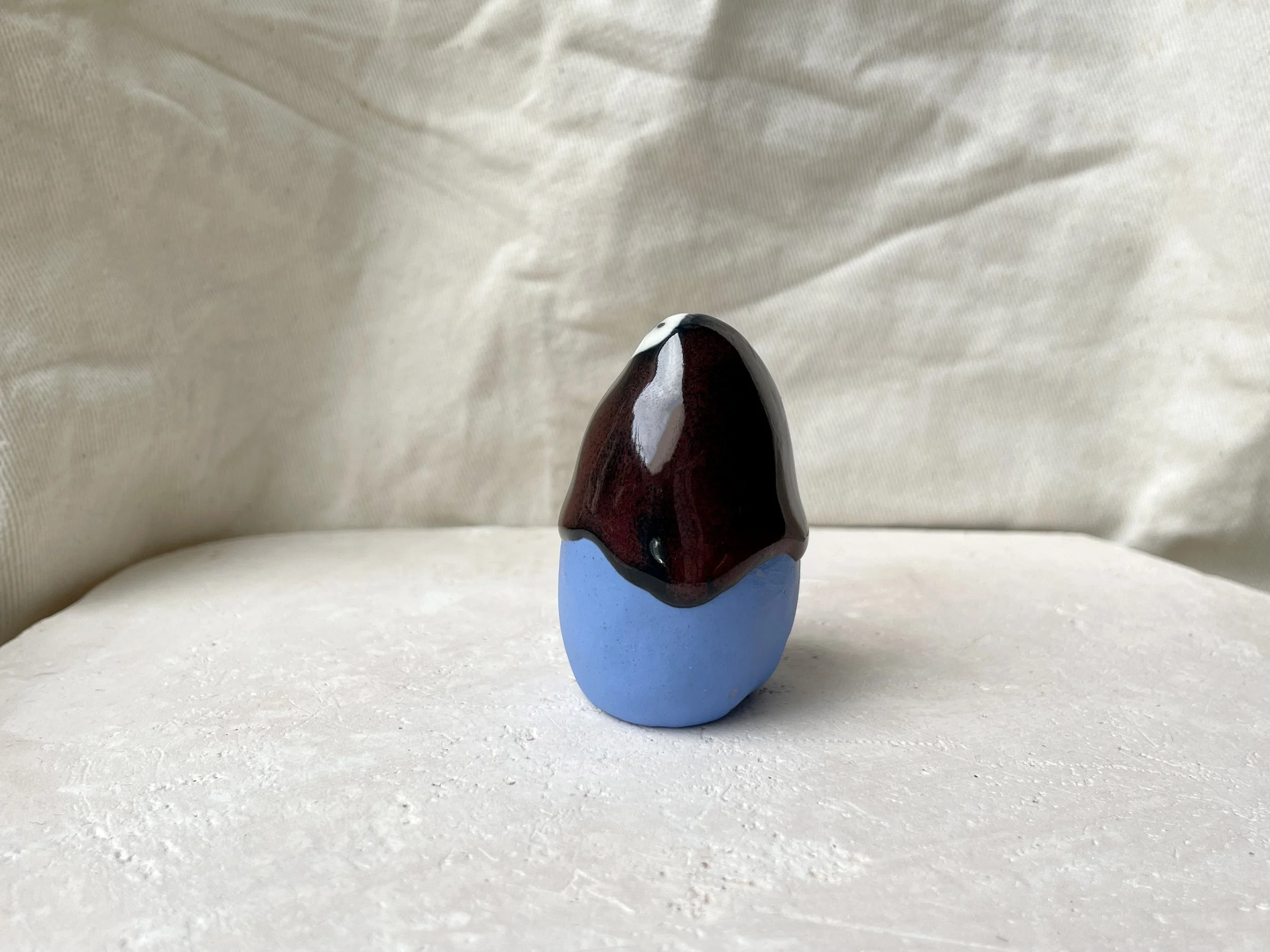 Blue, red and black handmade figurative ceramic sculpture with underglaze and drippy float glaze