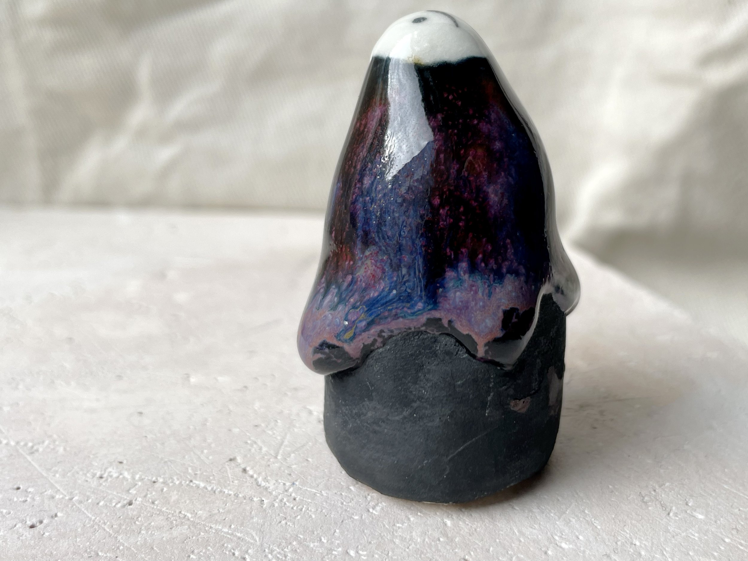 black, lilac and purple drippy handmade figurative ceramic sculpture with glossy floating glaze