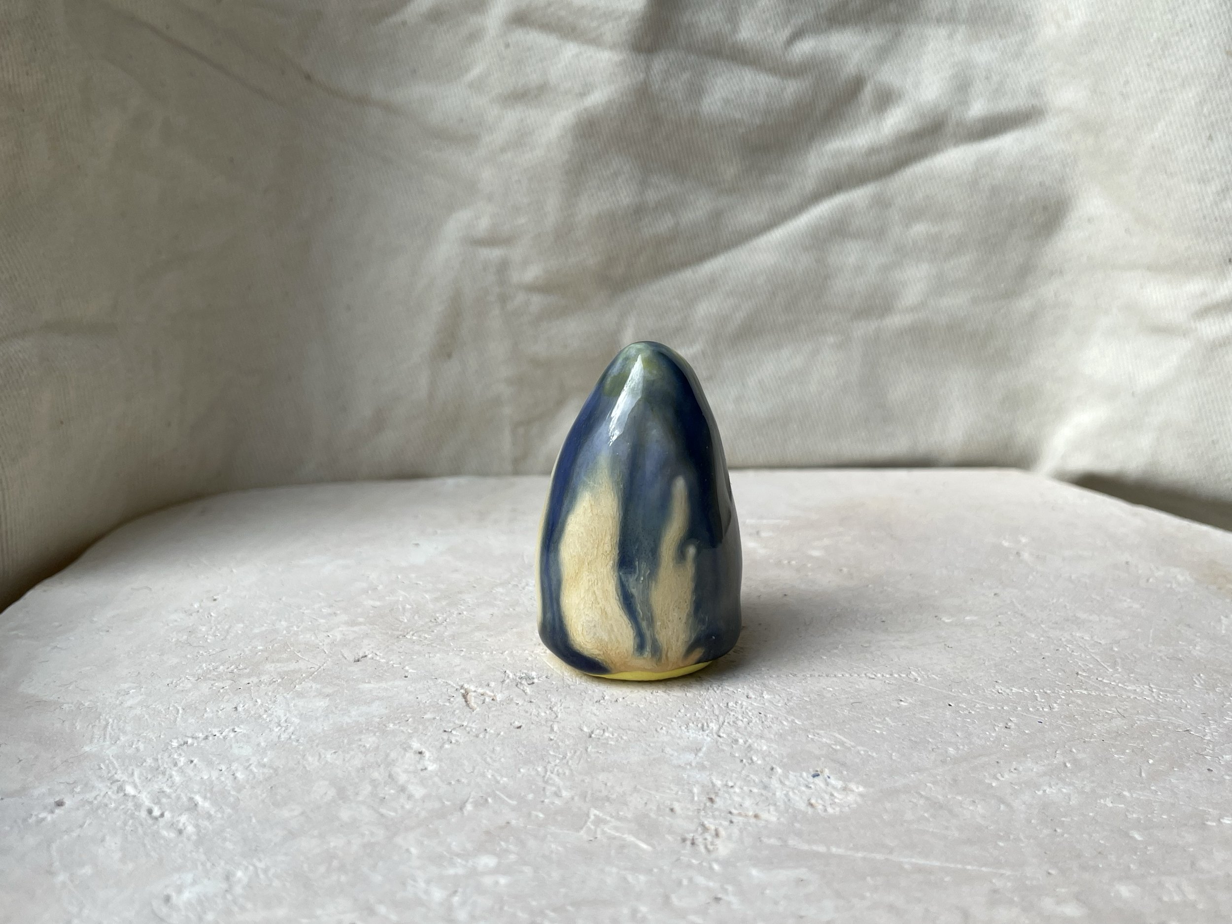 Yellow, blue and cream handmade figurative ceramic sculpture with glossy drippy glaze