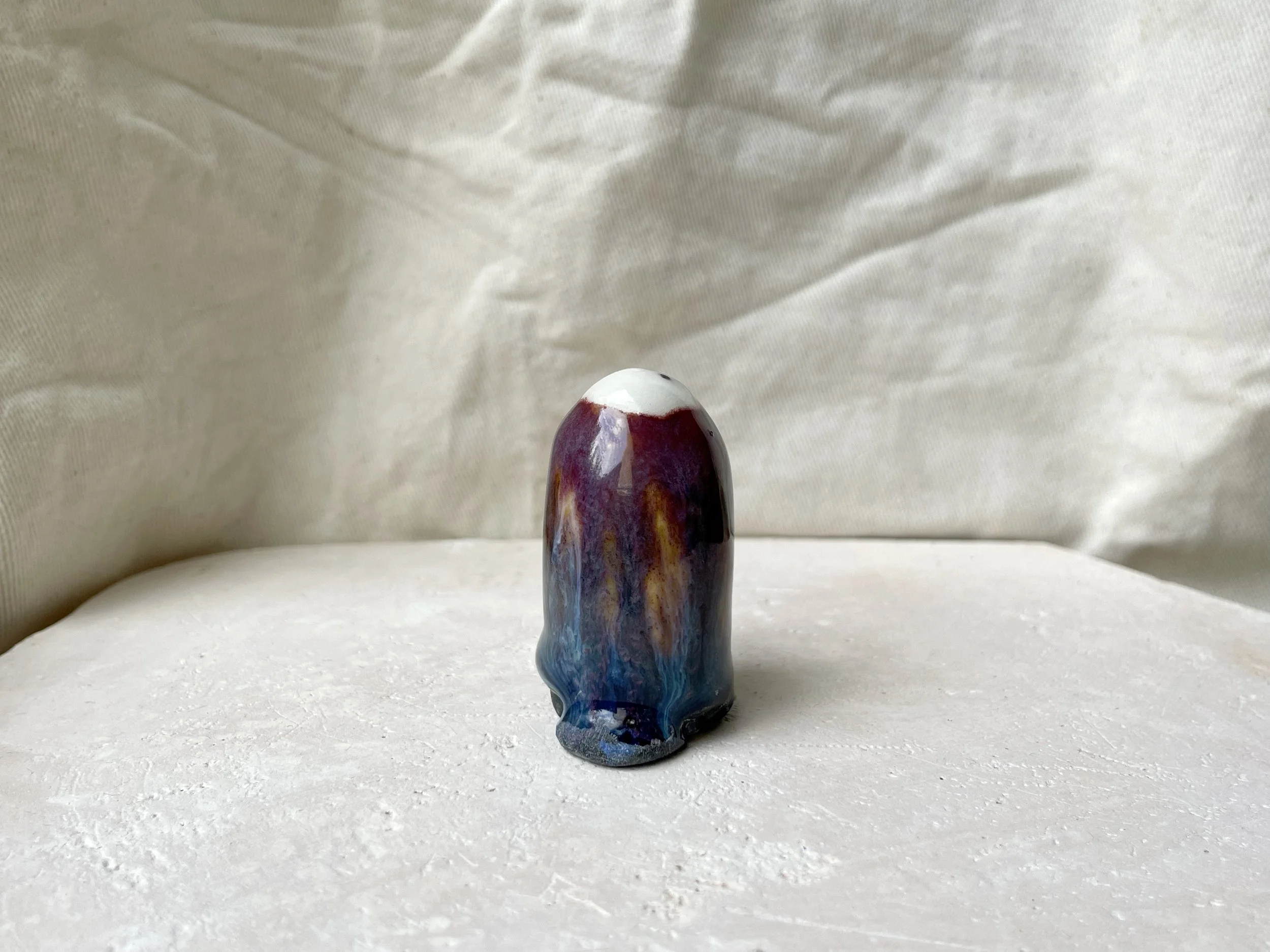 Purple, orange, blue and black handmade figurative ceramic sculpture with underglaze and drippy float glaze