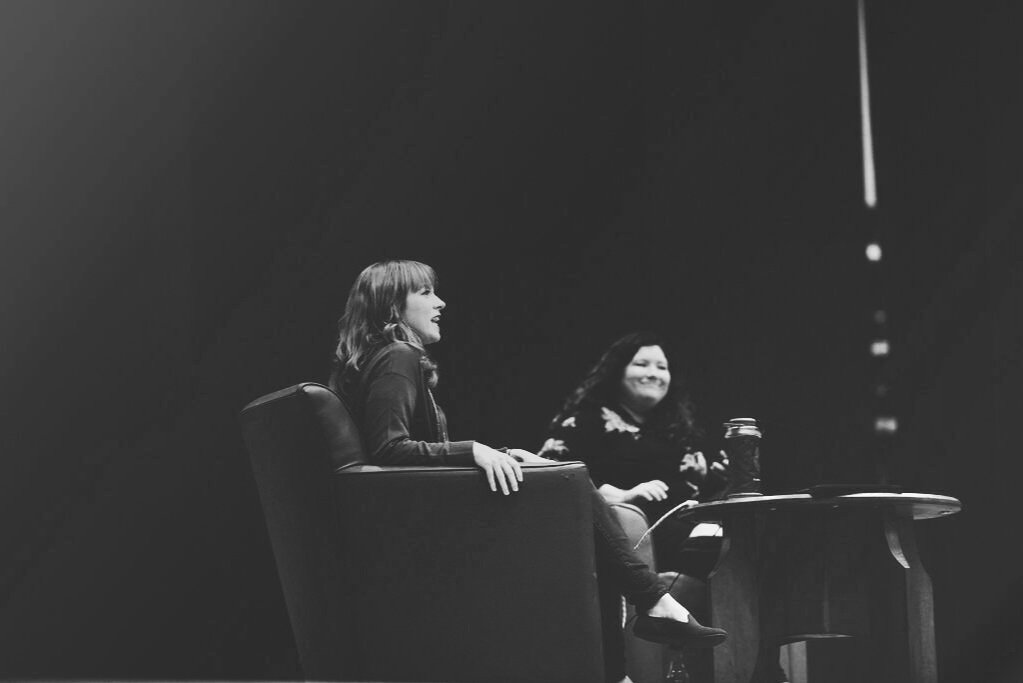 Sarah and Beth doing a live podcast on stage