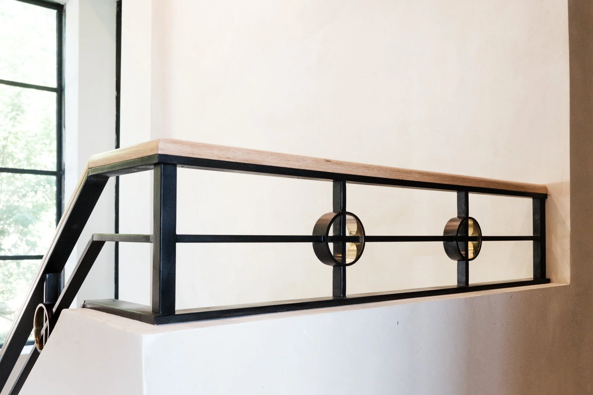 Custom steel railing with brass and white oak for a home renovation in cashiers, nc