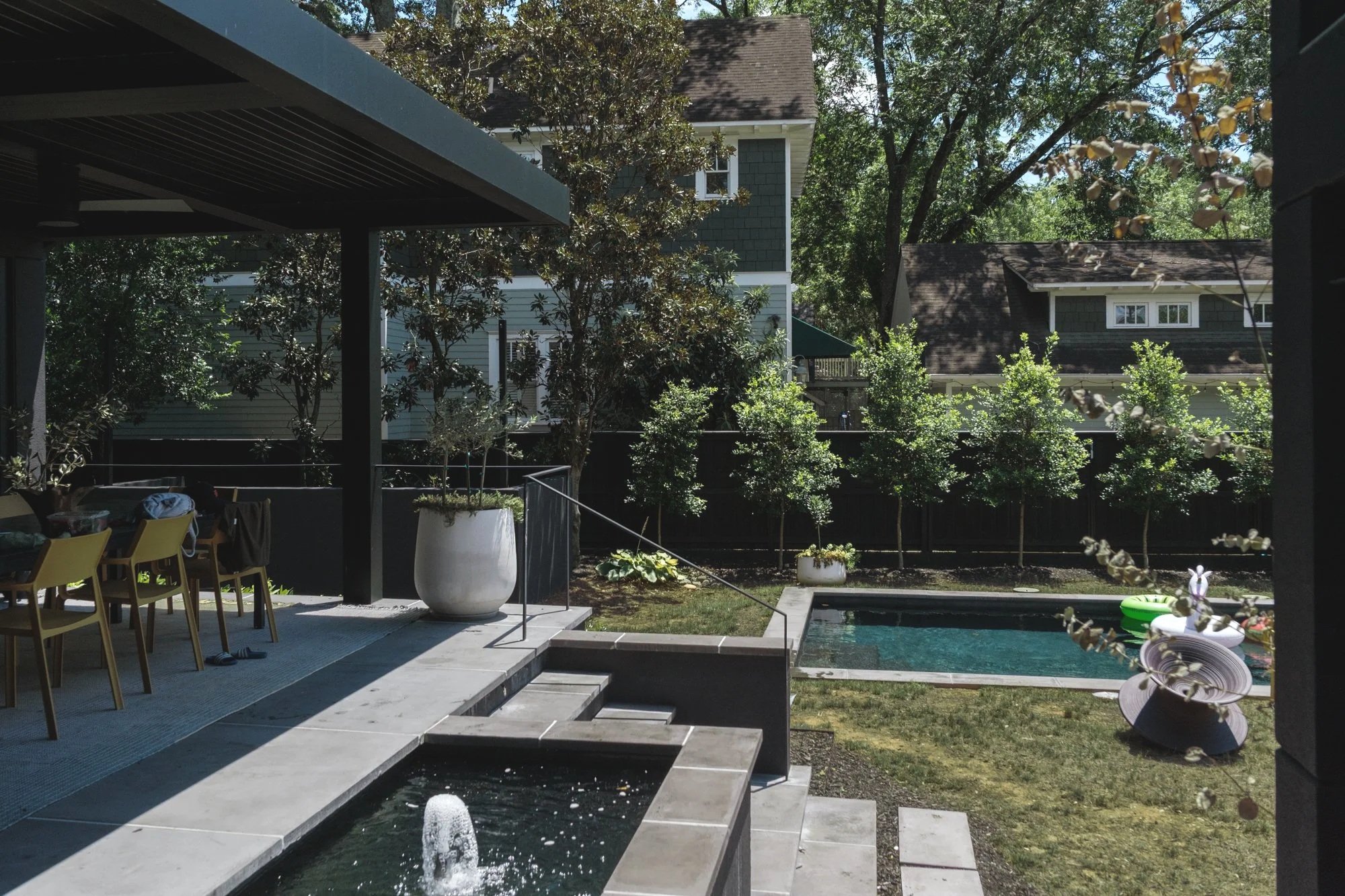 image of a backyard showcasing an exterior custom steel minimal grab descent railing