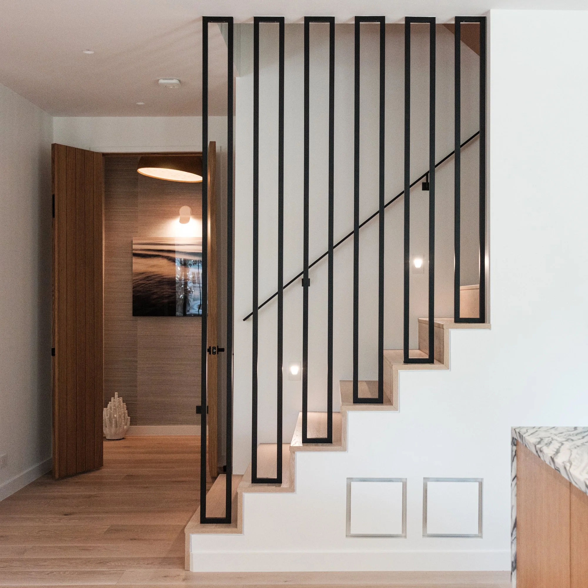 Interior custom steel dividers on stair descent with grabrailing