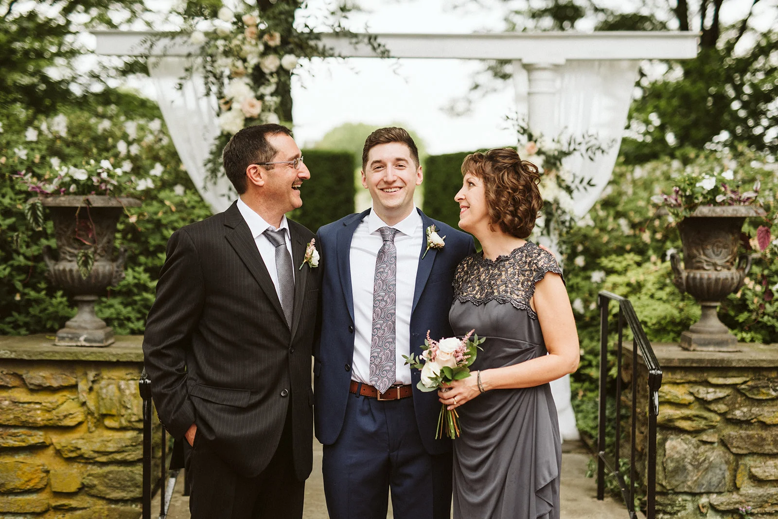Andrew and his parents during family formals after their wedding ceremony.