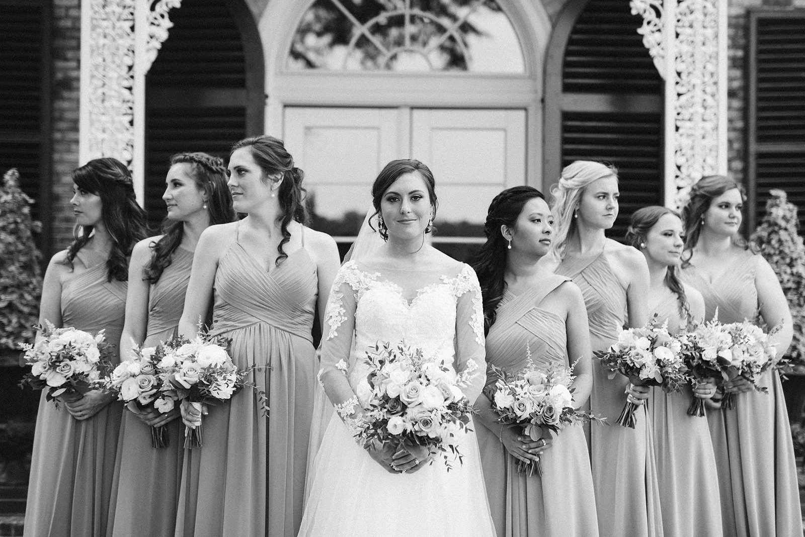Jana and her bridesmaids pose in front of the mansion at Drumore Estate.