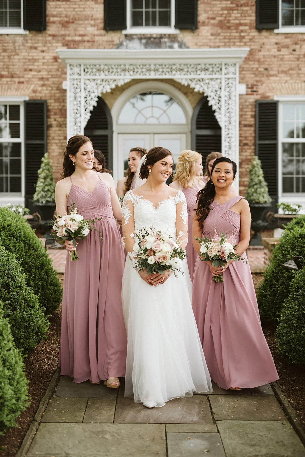 Bride and bridesmaids walking through the estate grounds at their Drumore wedding.