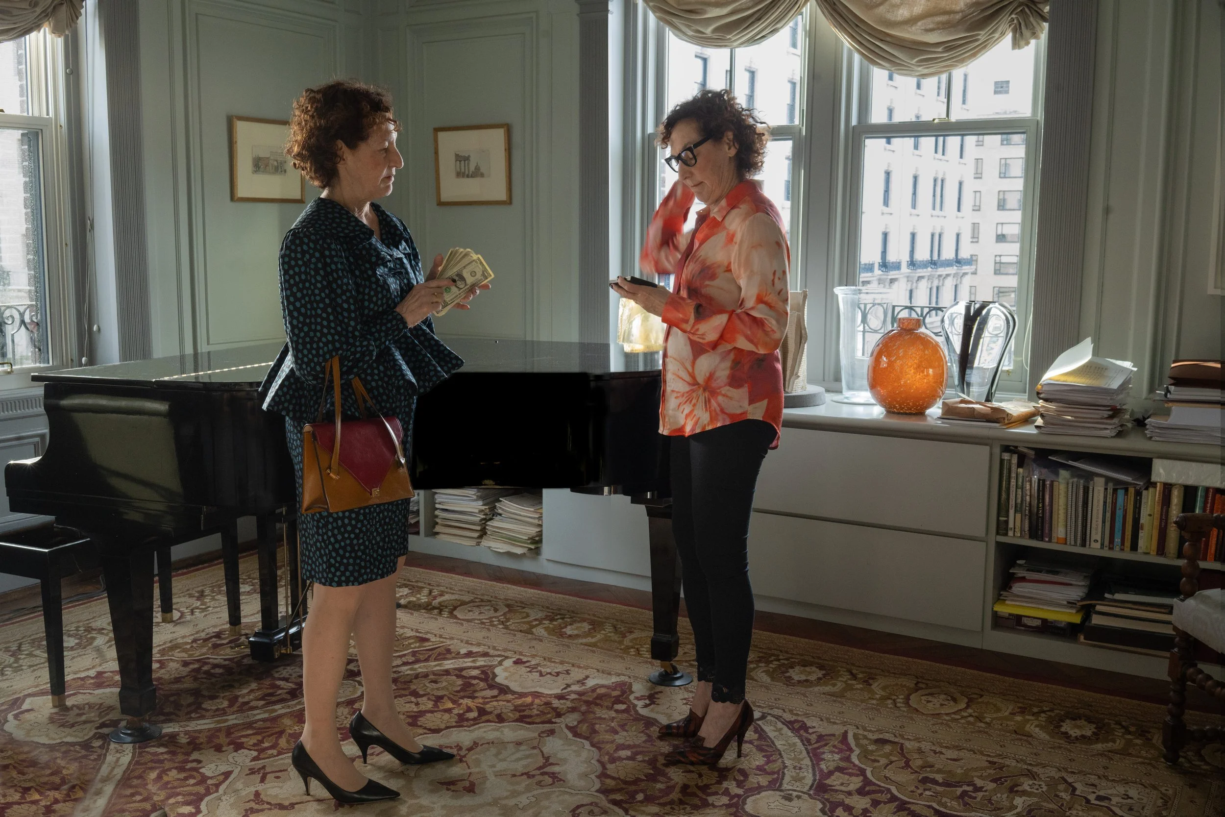   Left: Shirt and skirt by Chloé, pumps by The Row, tights by Falke and bag by Versace.    Right: Shirt by Marciano by Guess, leggings by Guess, pumps by Versace and glasses by Saint Laurent by Anthony Vaccarello.  