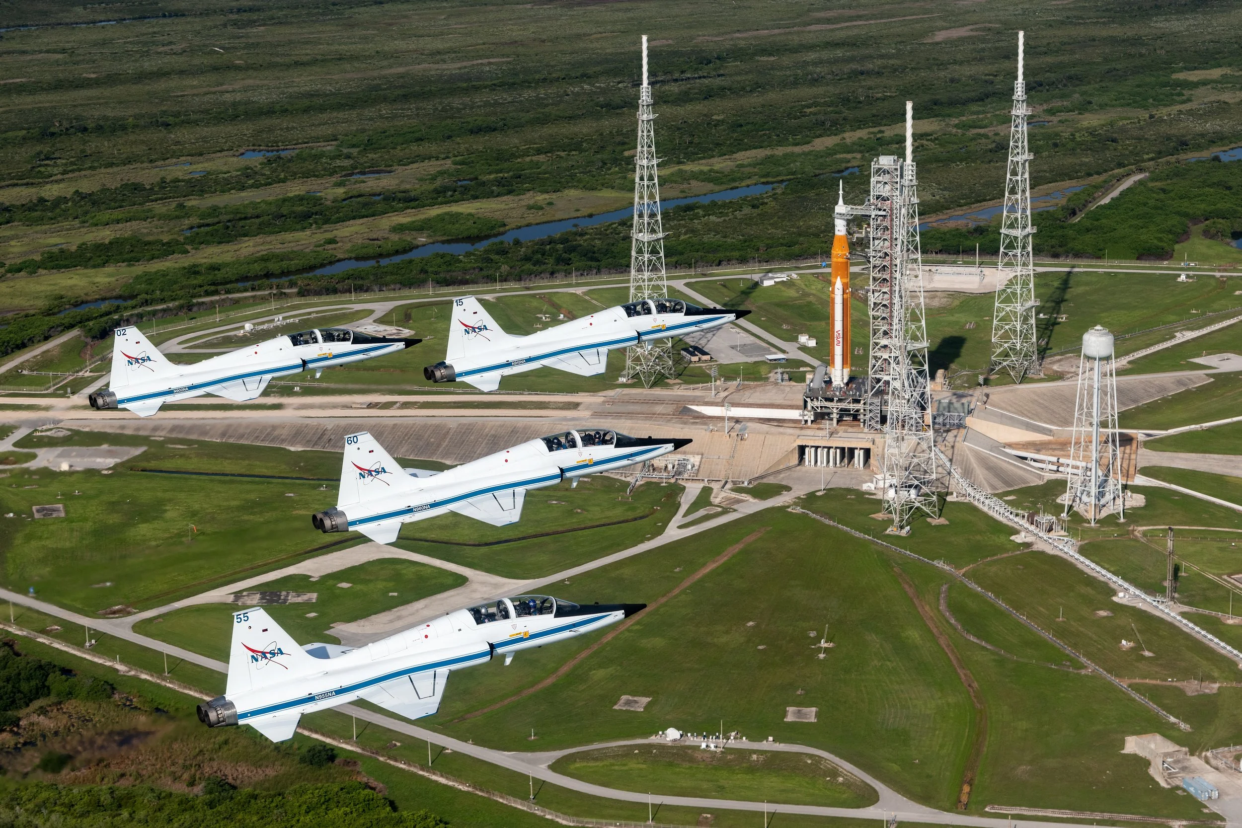  NASA astronauts piloting T-38 jets soar in formation above the Artemis I rocket on Launch Pad 39B as it awaits launch at NASA's Kennedy Space Center.  Photo: NASA/Josh Valcarcel (jsc2022e066538_alt)  Nikon D850 f/5.6, 1/4000 sec, ISO 400 