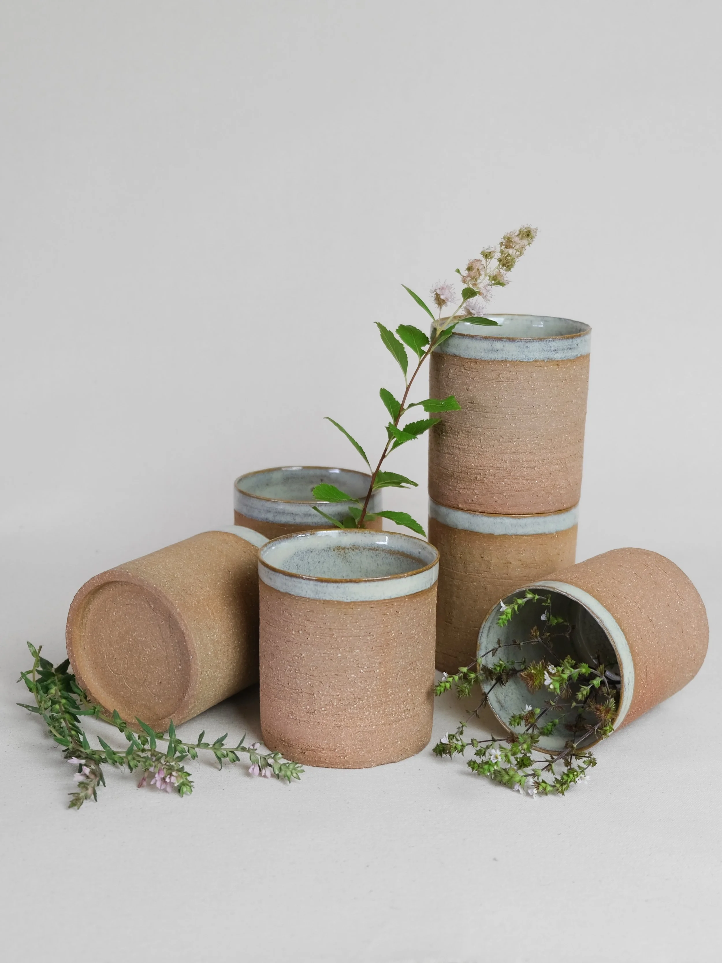 Tumblers ~~

Groggy red clay, glazed interior