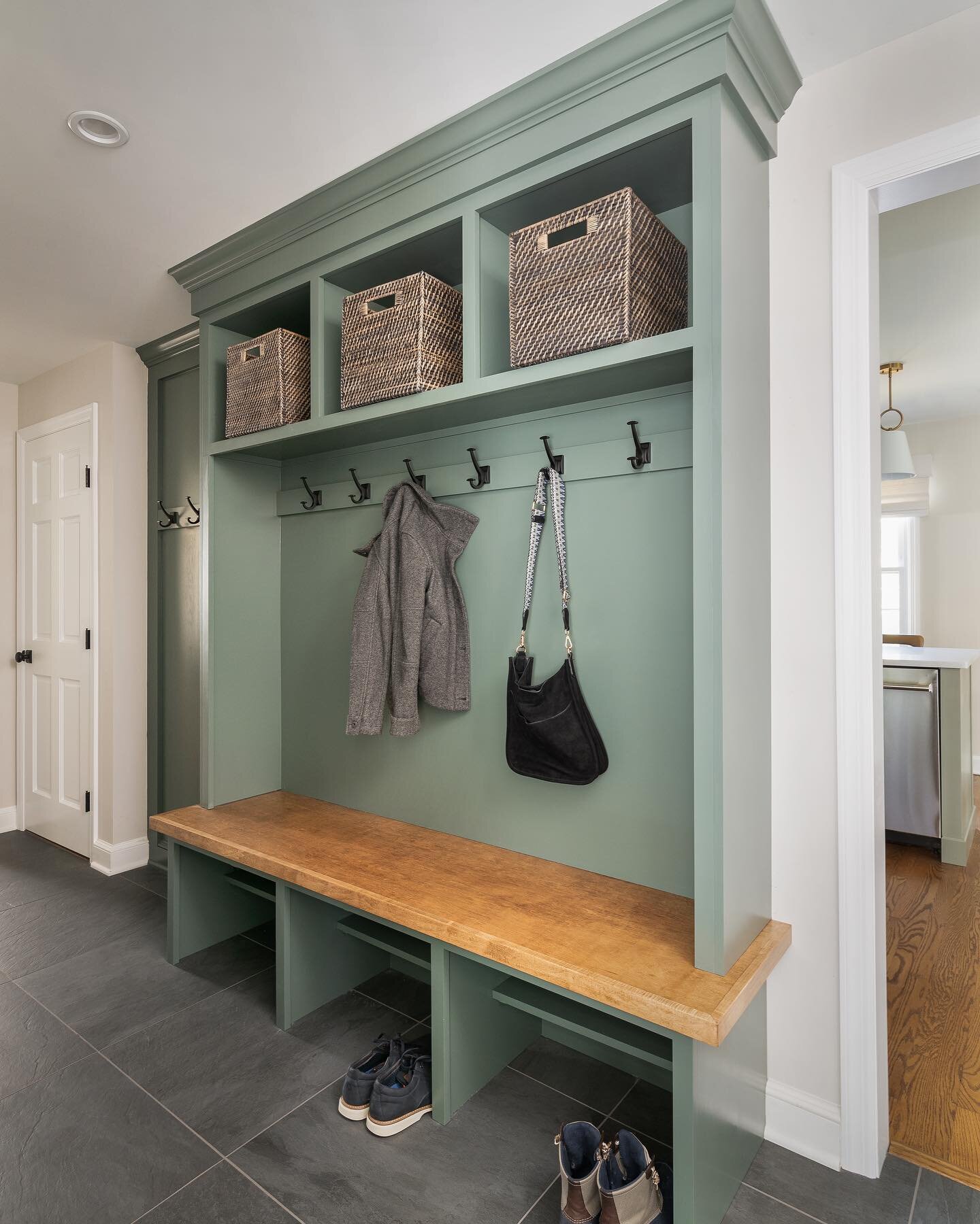 This newly completed mudroom is ready to take on soggy shoes and wet jackets. It&rsquo;s all about balance when it comes to mudrooms. We want them to be beautiful and functional. Cubbies painted in @sherwinwilliams Succulent is such a pleasing backdr