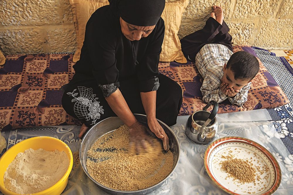 This photo, taken as part of Saveur 's feature called "The Heart of Palestine", shows the process of making maftoul from scratch. The recipe I followed to make maftoul was part of this feature. Photo by Saveur . 