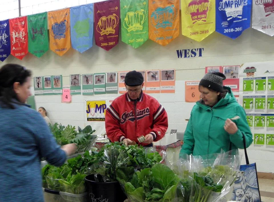 Spinach farmers at the Oberlin Winter Market. Talk to them about spinach! That you will eat! Delicious! From Oberlin Winter Market.