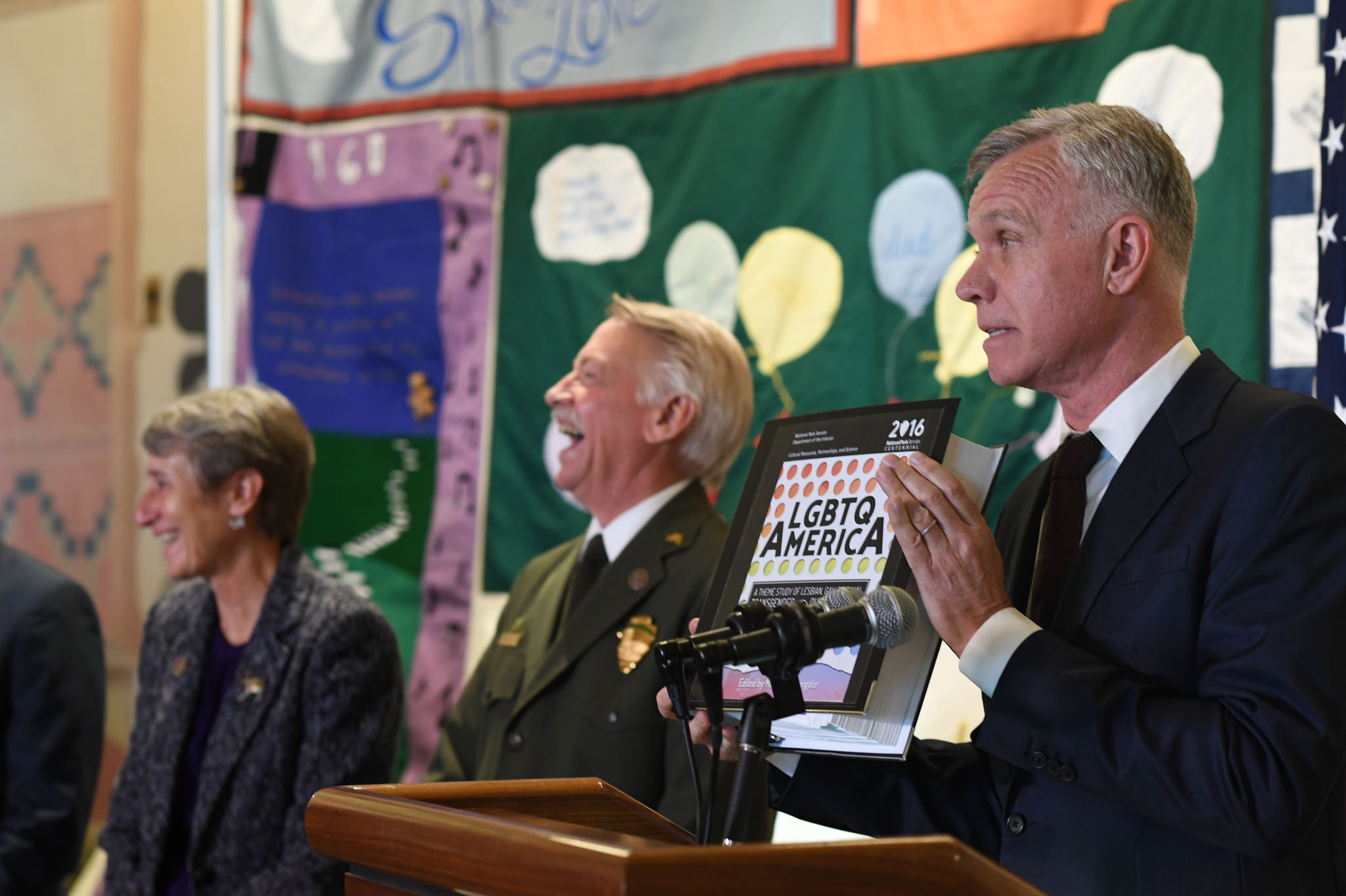 Tim Gill, right, speaks at a press conference for the release of the U.S. Interior Department's "LGBTQ America" report in October 2016. 
