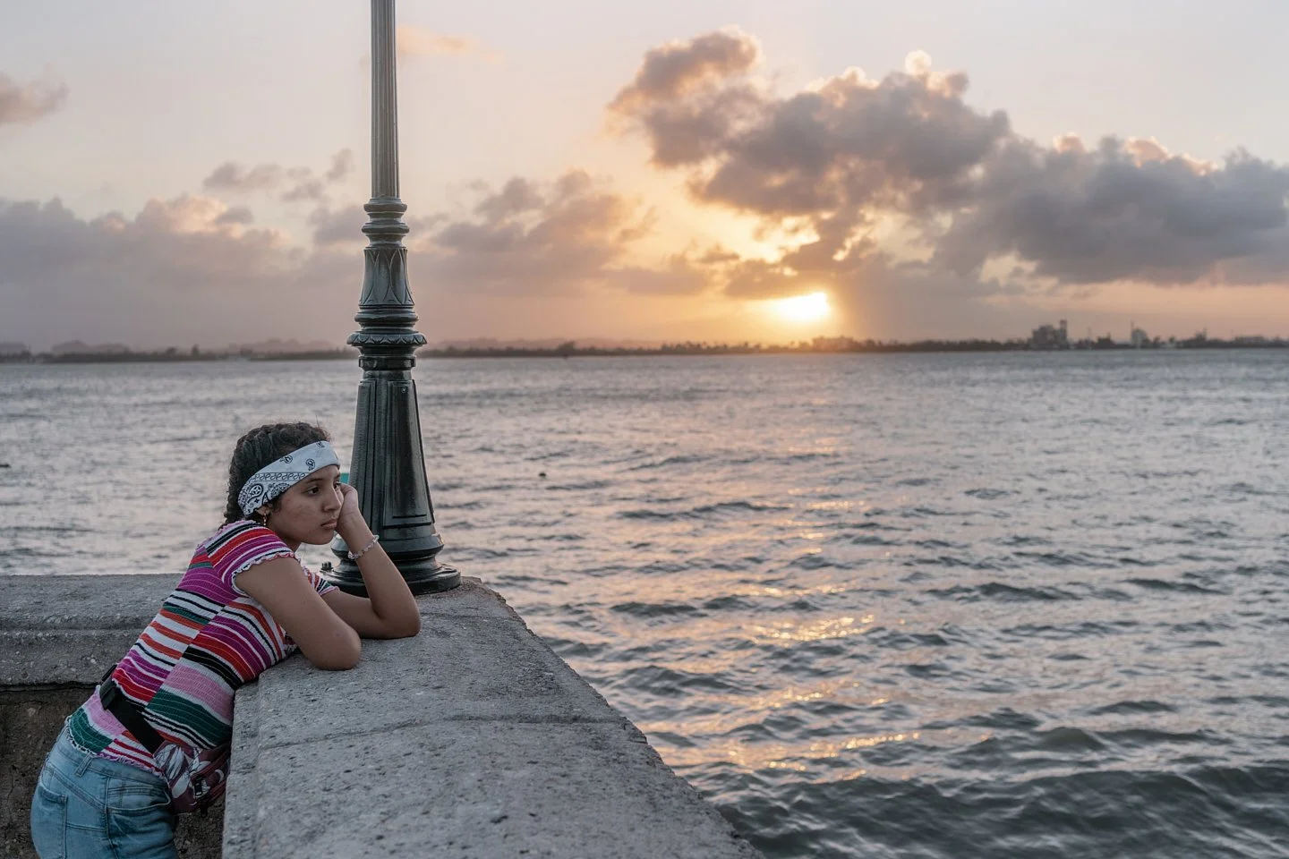 As San Juan prepares for the San Sebastián Street Festival, a young girl stares out towards the sea in the old city. On December 28th, 2019, the south of the island began experience devastating earthquakes which destroyed homes, schools, medical fac