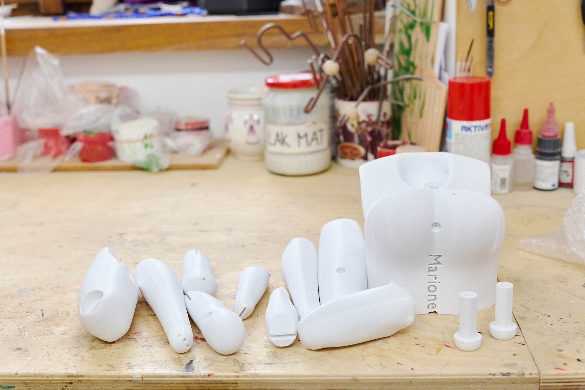  The pieces of a marionette awaiting to be assembled in the workshop of Czech Marionettes. Many of the puppets made in the workshop behind the store front are 3D printed and hand painted and assembled.  