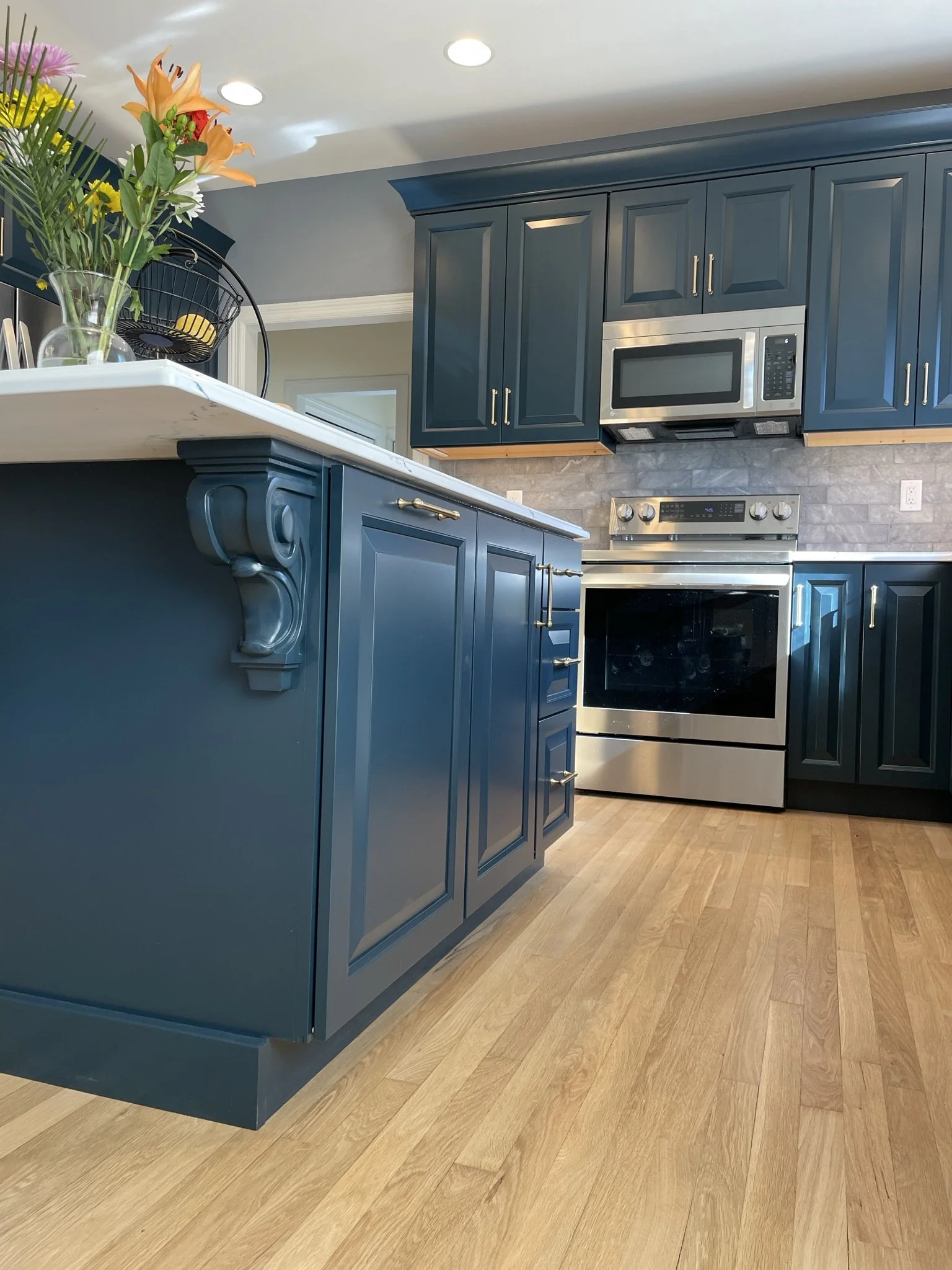  The brushed gold pulls work well with the teal cabinets 